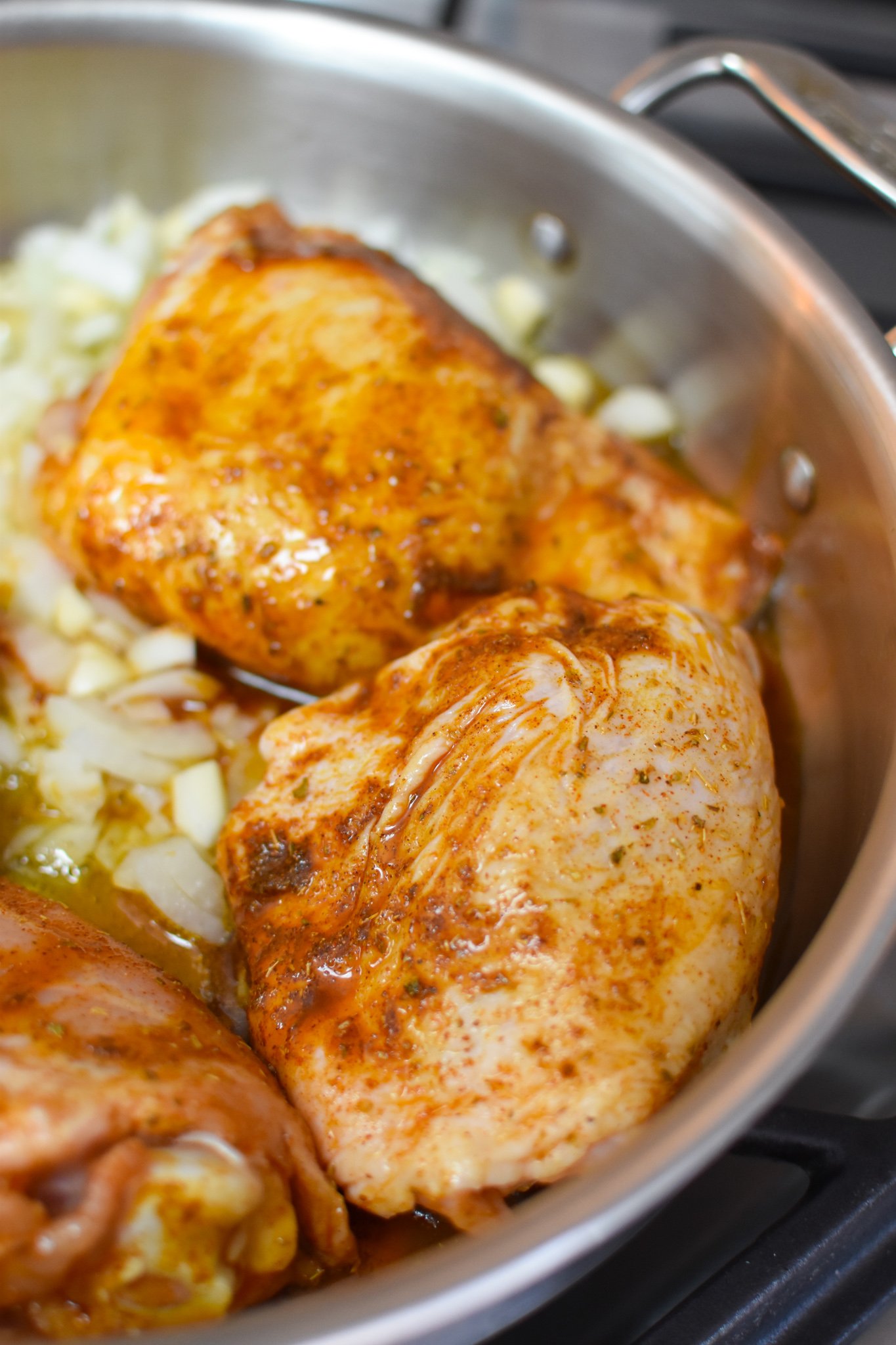 One Pot Mediterranean Chicken and Rice in a skillet.