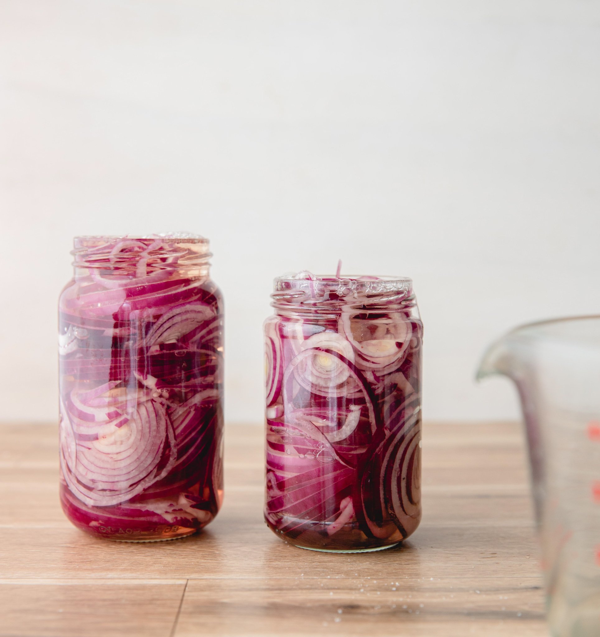 Quick Pickled Red Onions in two mason jars.