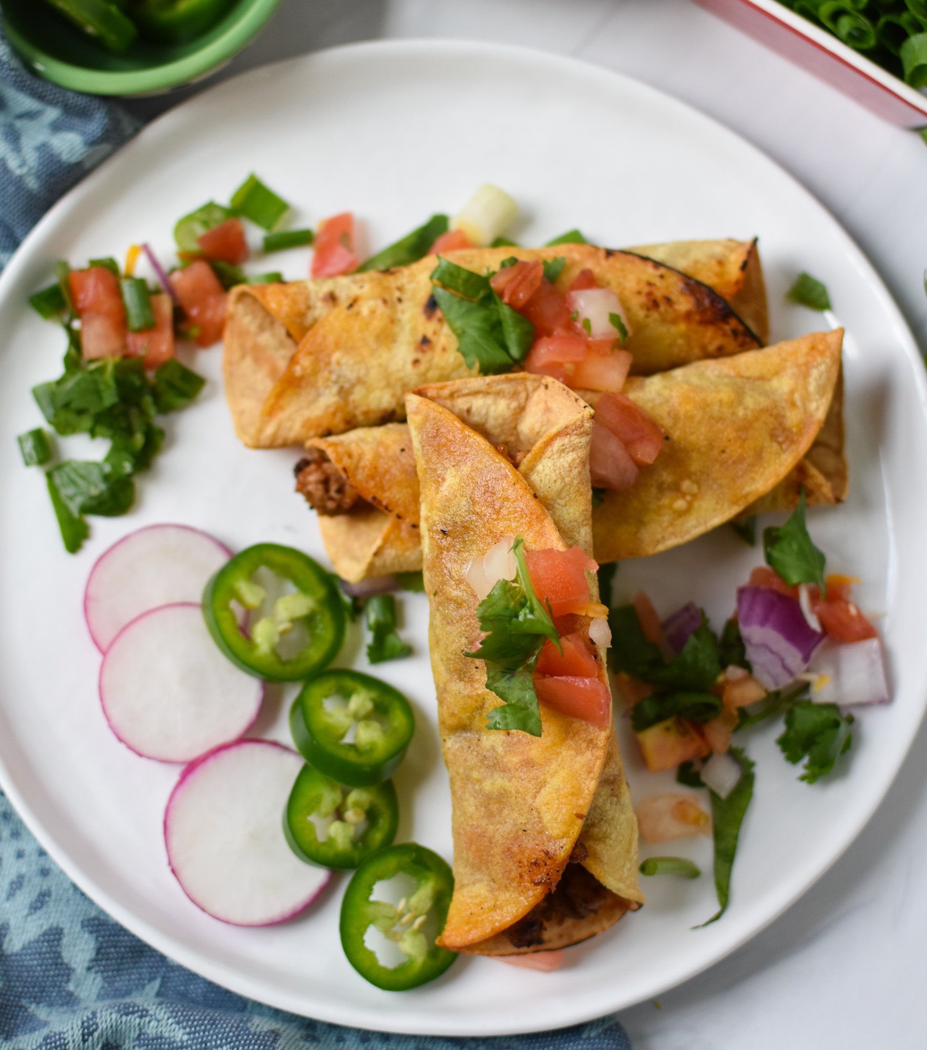 Air Fryer Pork Taquitos with radishes.