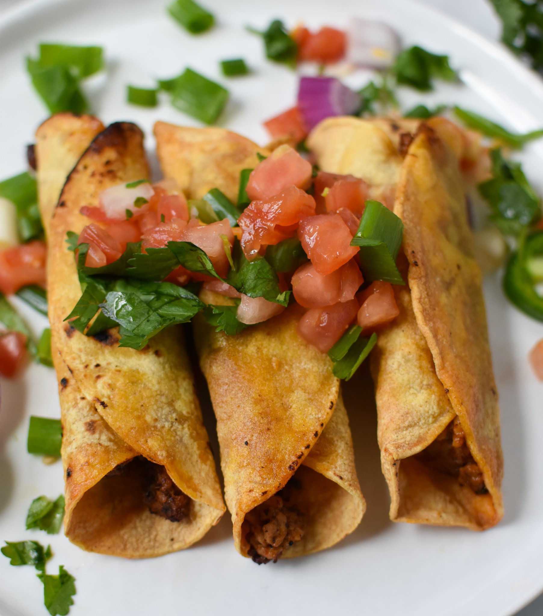Air Fryer Pork Taquitos on a white plate.
