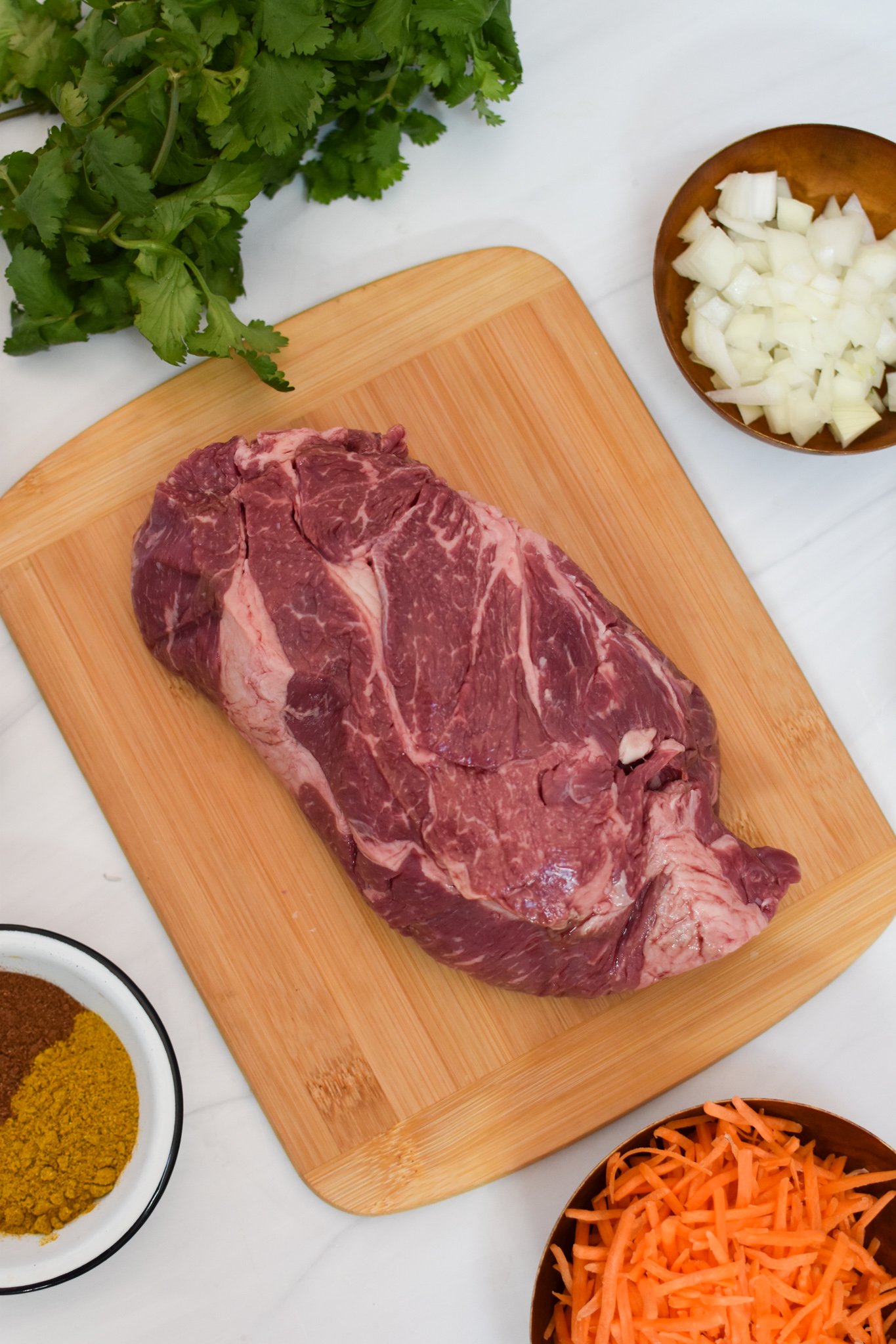Slow Cooker Beef Curry beef on a cutting board. 