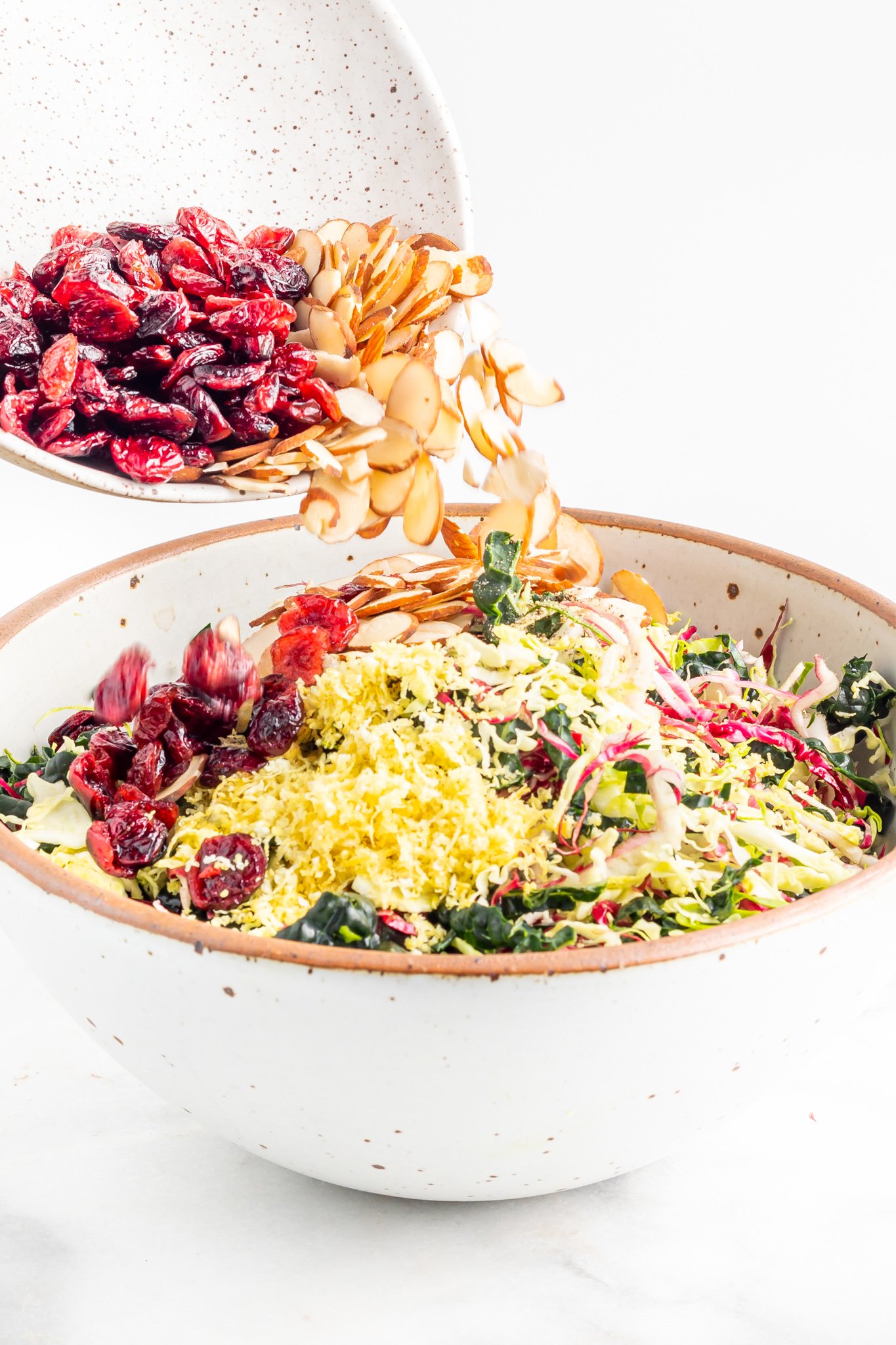 Winter Coleslaw Salad mixing the slaw together. 