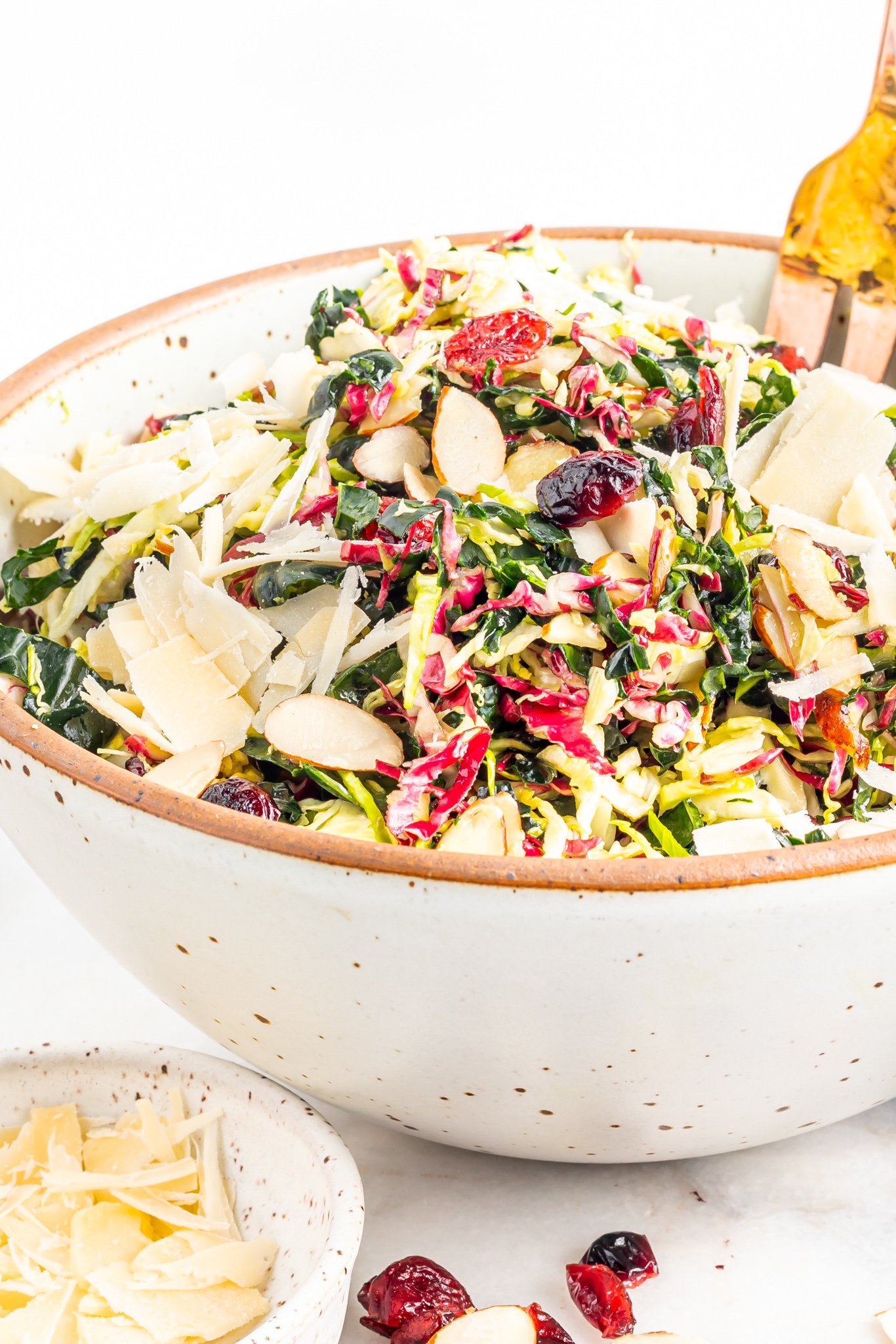 Winter Coleslaw Salad in a white bowl with a gold fork.