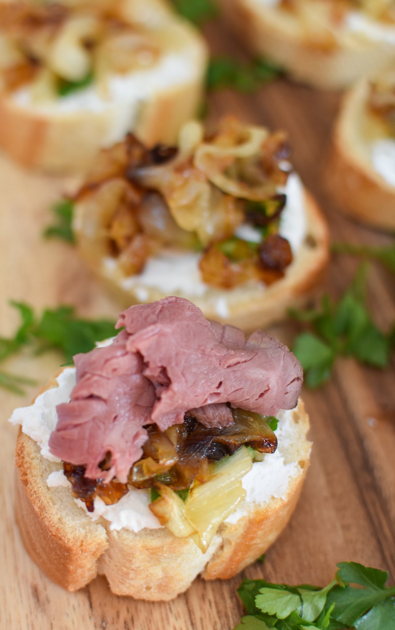 Beef Crostini with Caramelized Onion and Goat Cheese with goat cheese and onions. 