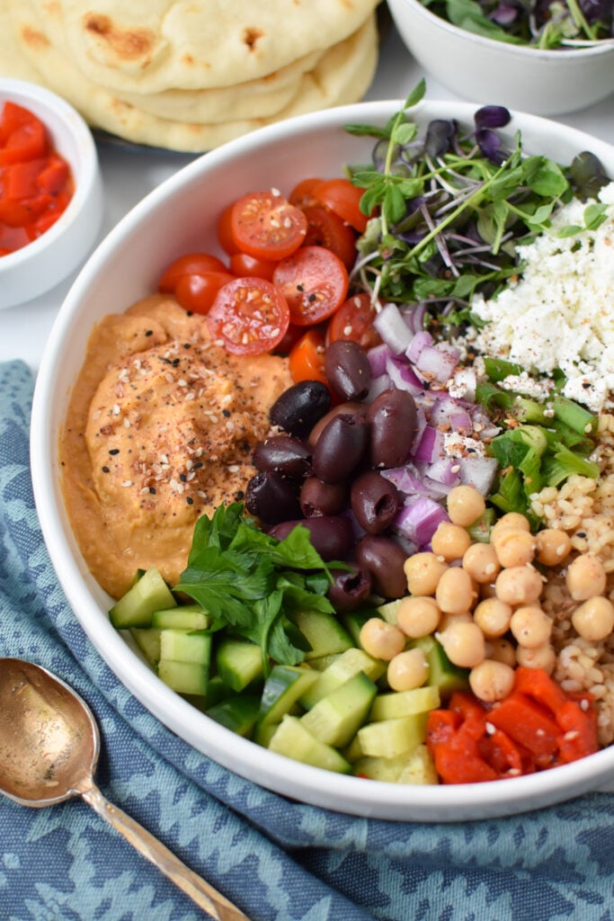 Easy Mediterranean Hummus Bowl in a white bowl.