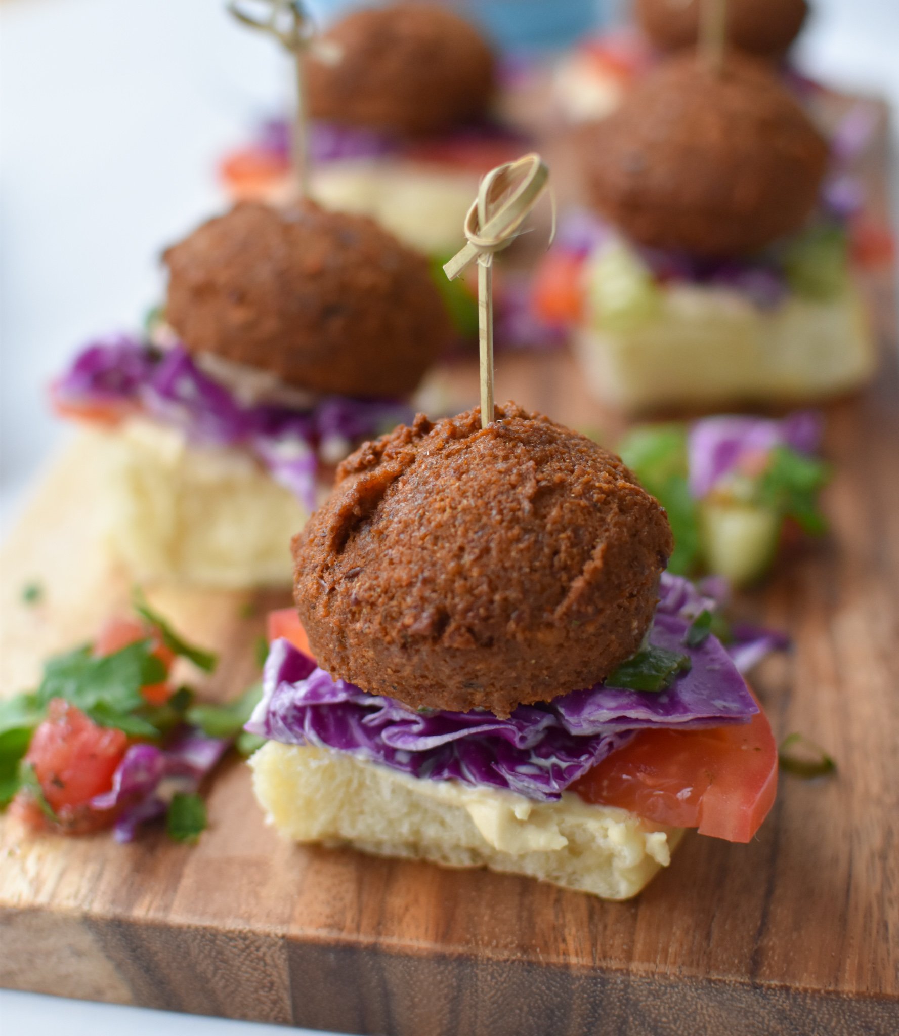 Falafel Sliders with Tahini Slaw on a cutting board. 