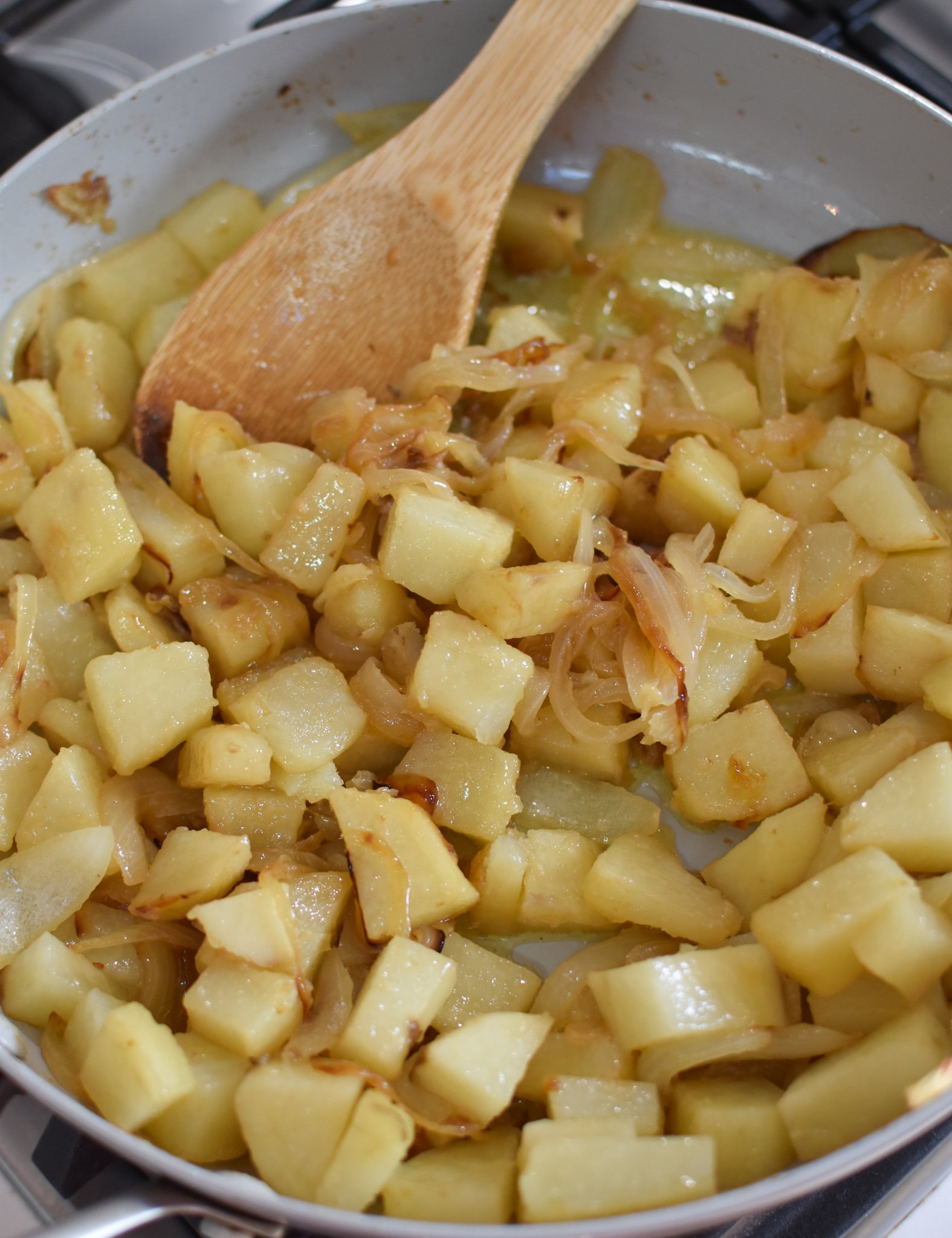 Lebanese Potato and Egg Recipe potatoes and onions in a skillet. 