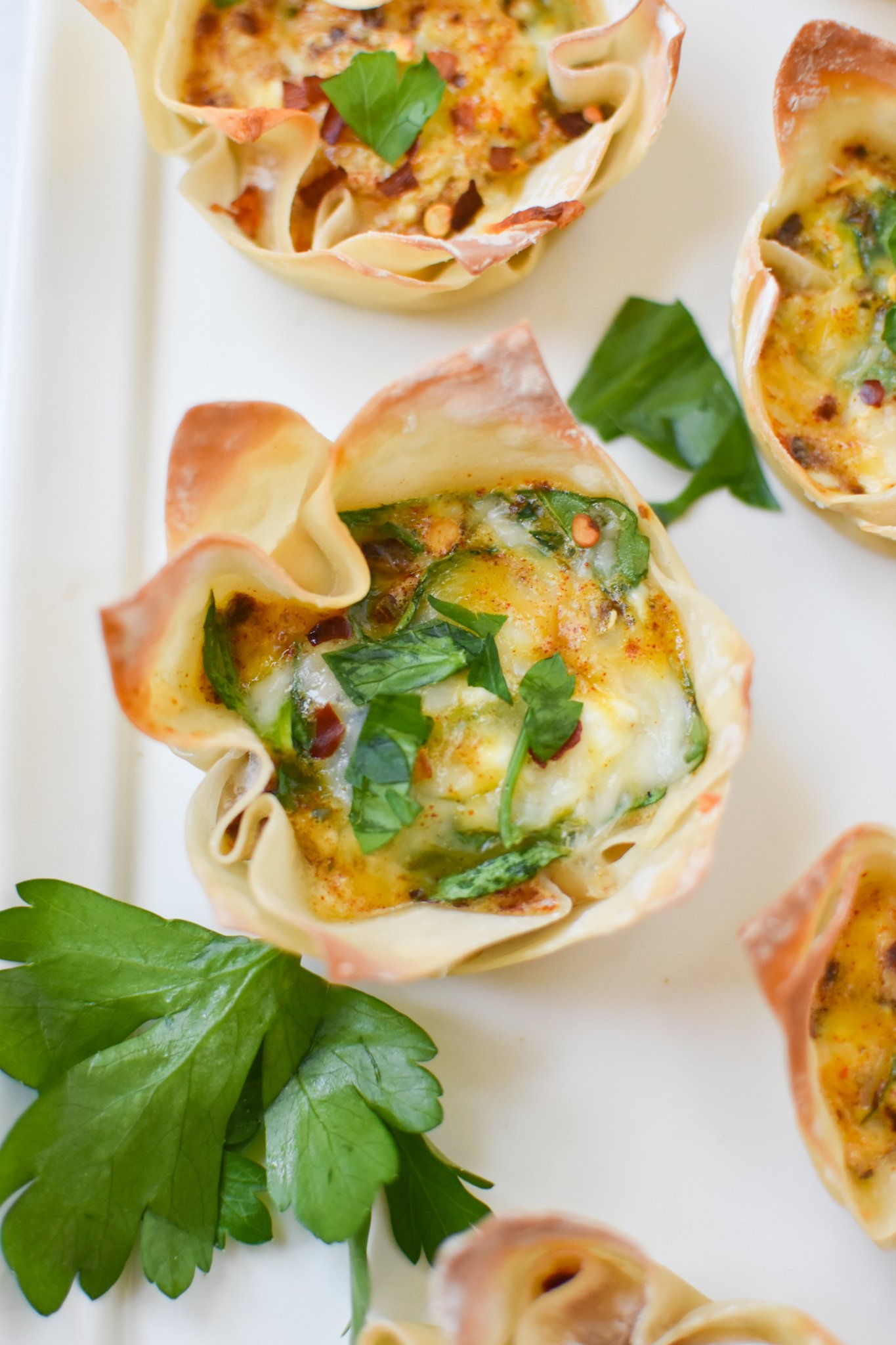 Mediterranean Quiche Wontons on a white platter.