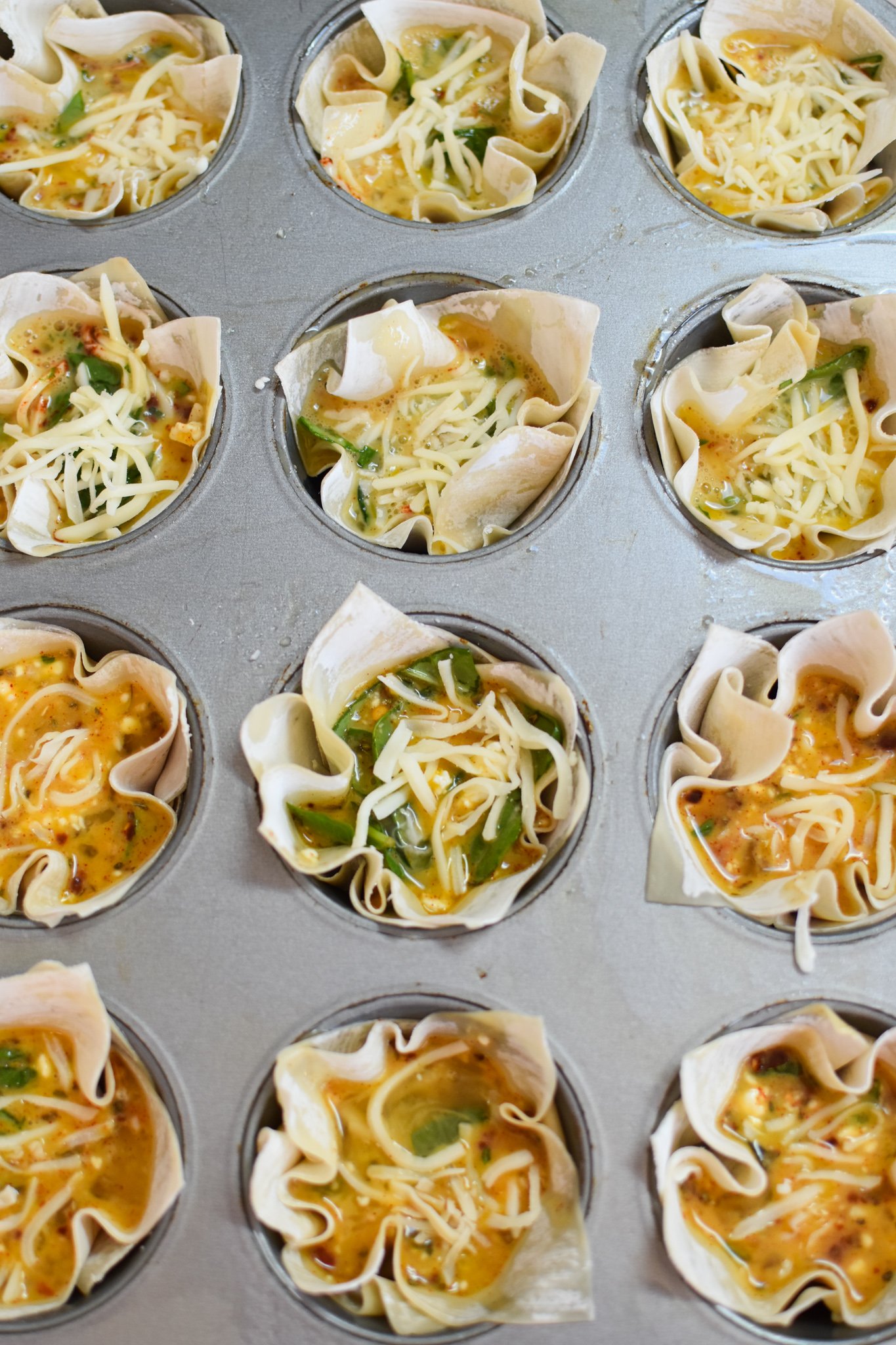 Mediterranean Quiche Wontons in the muffin tin.