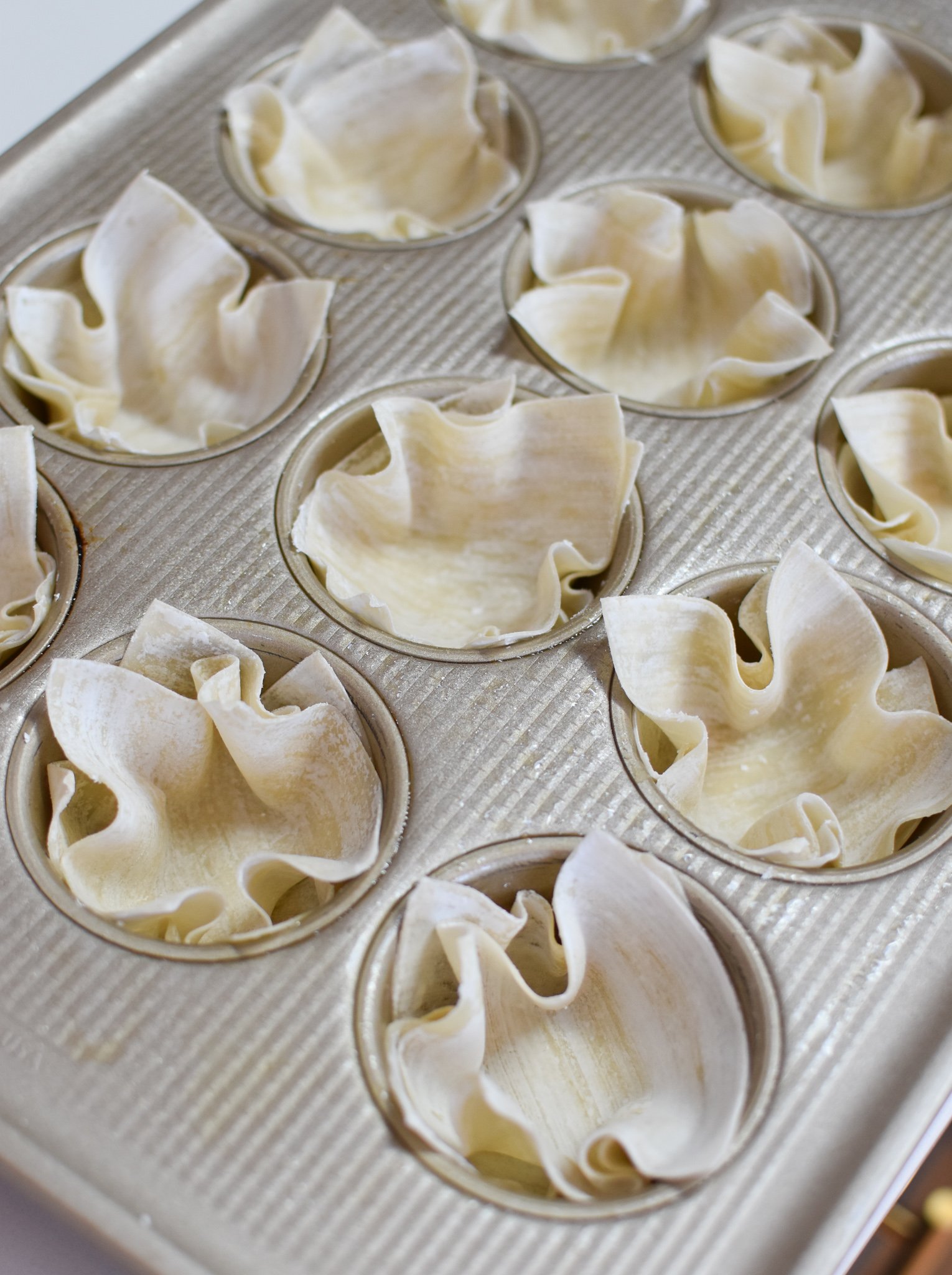Mediterranean Quiche Wontons in a muffin tin.