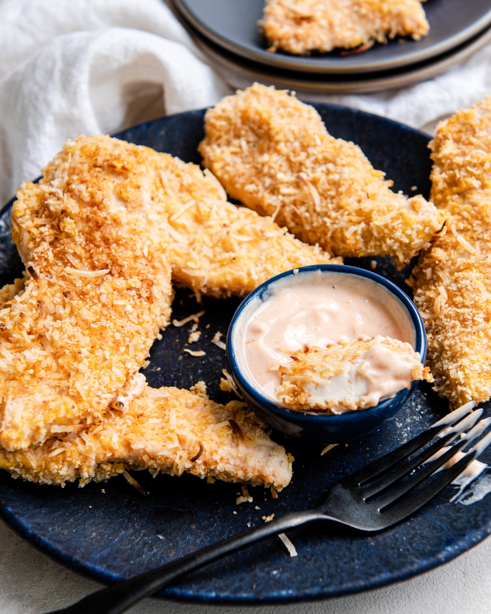 Air Fryer Coconut Chicken Tenders with sauce.