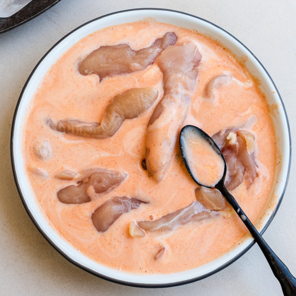 Air Fryer Coconut Chicken Tenders in a buttermilk mixture.