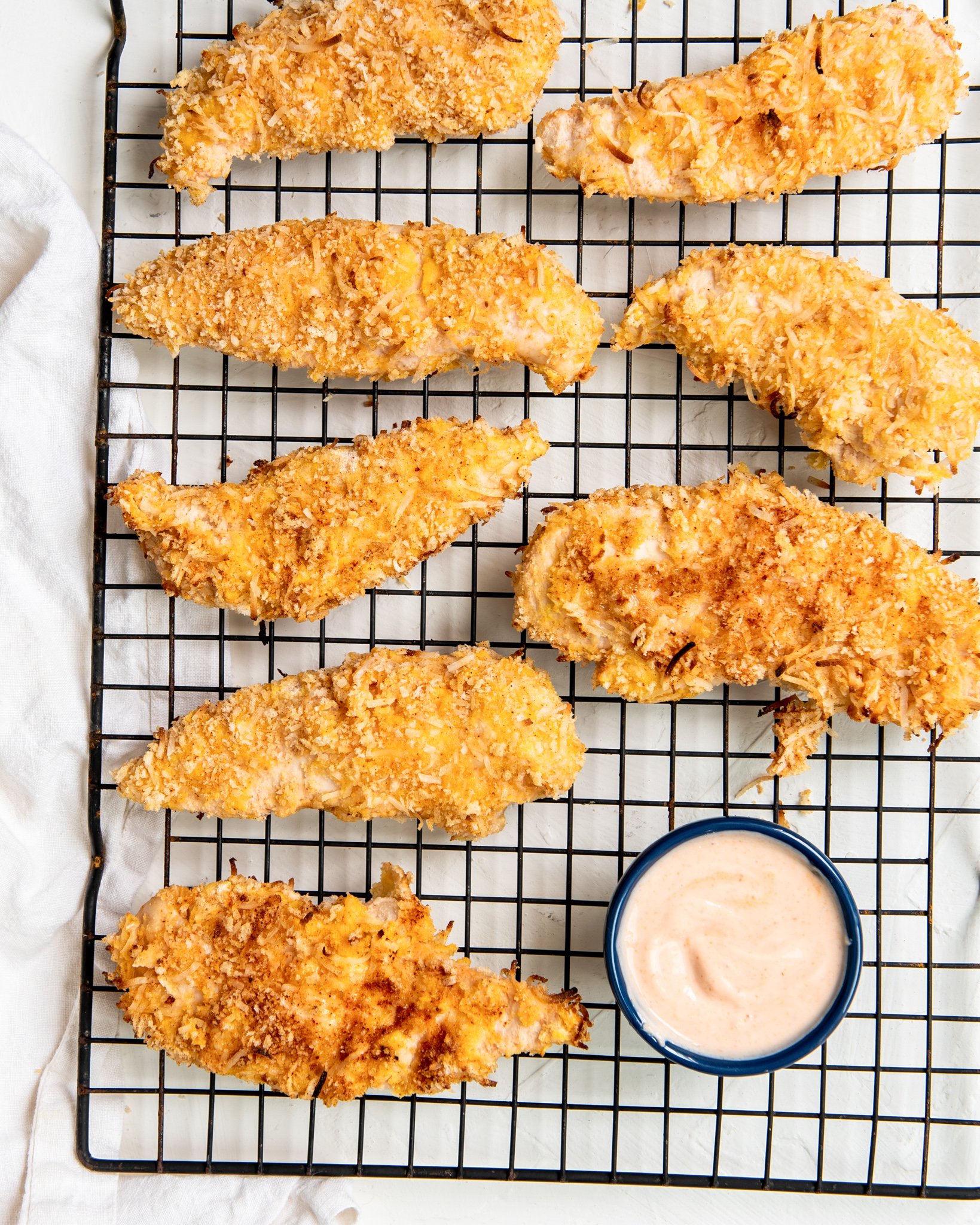 Air Fryer Coconut Chicken Tenders on a baking rack.