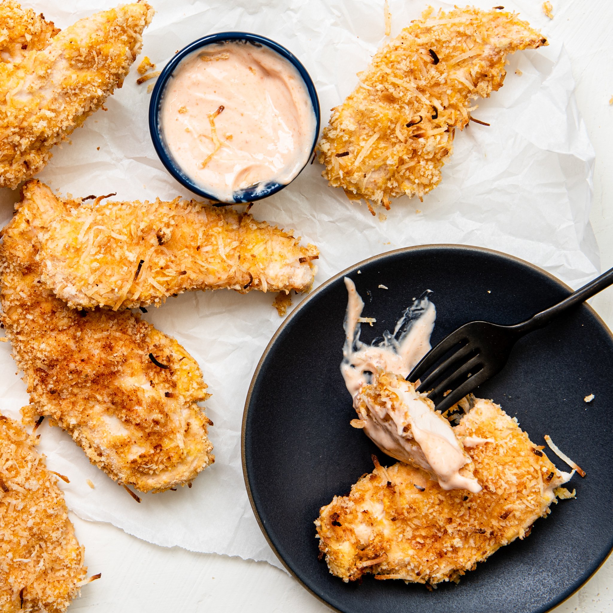 Air Fryer Coconut Chicken Tenders with a fork.