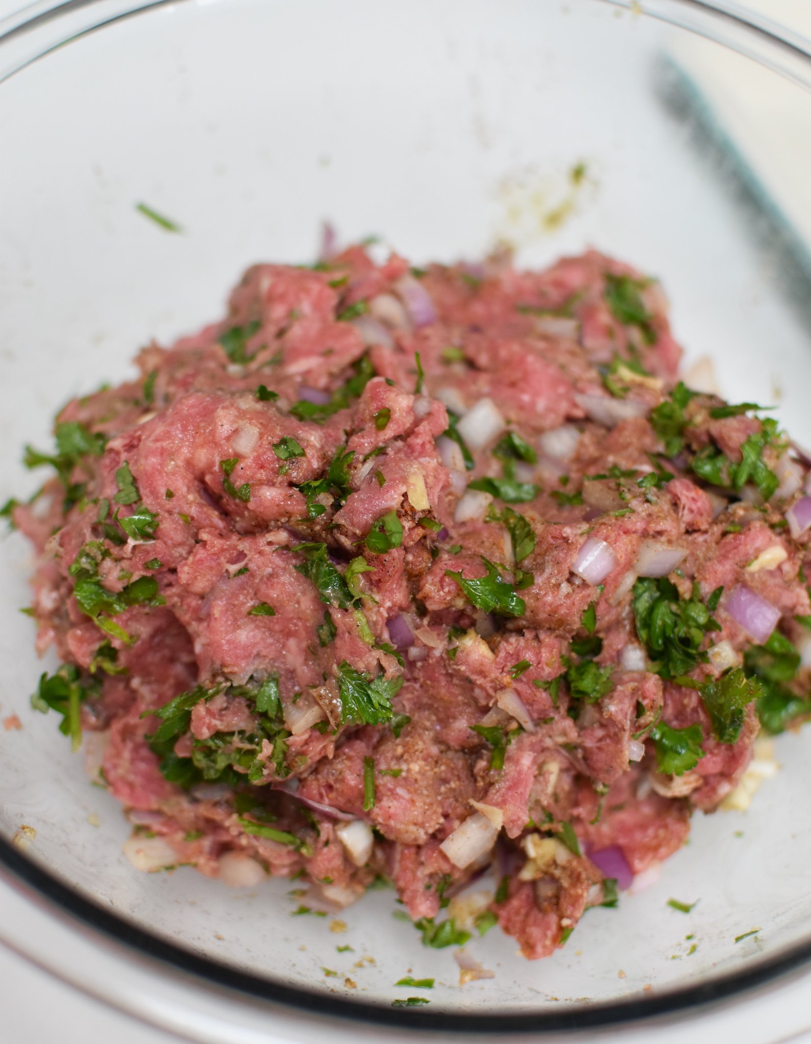 Mediterranean Baked Beef Meatballs meatball mixture in a bowl. 