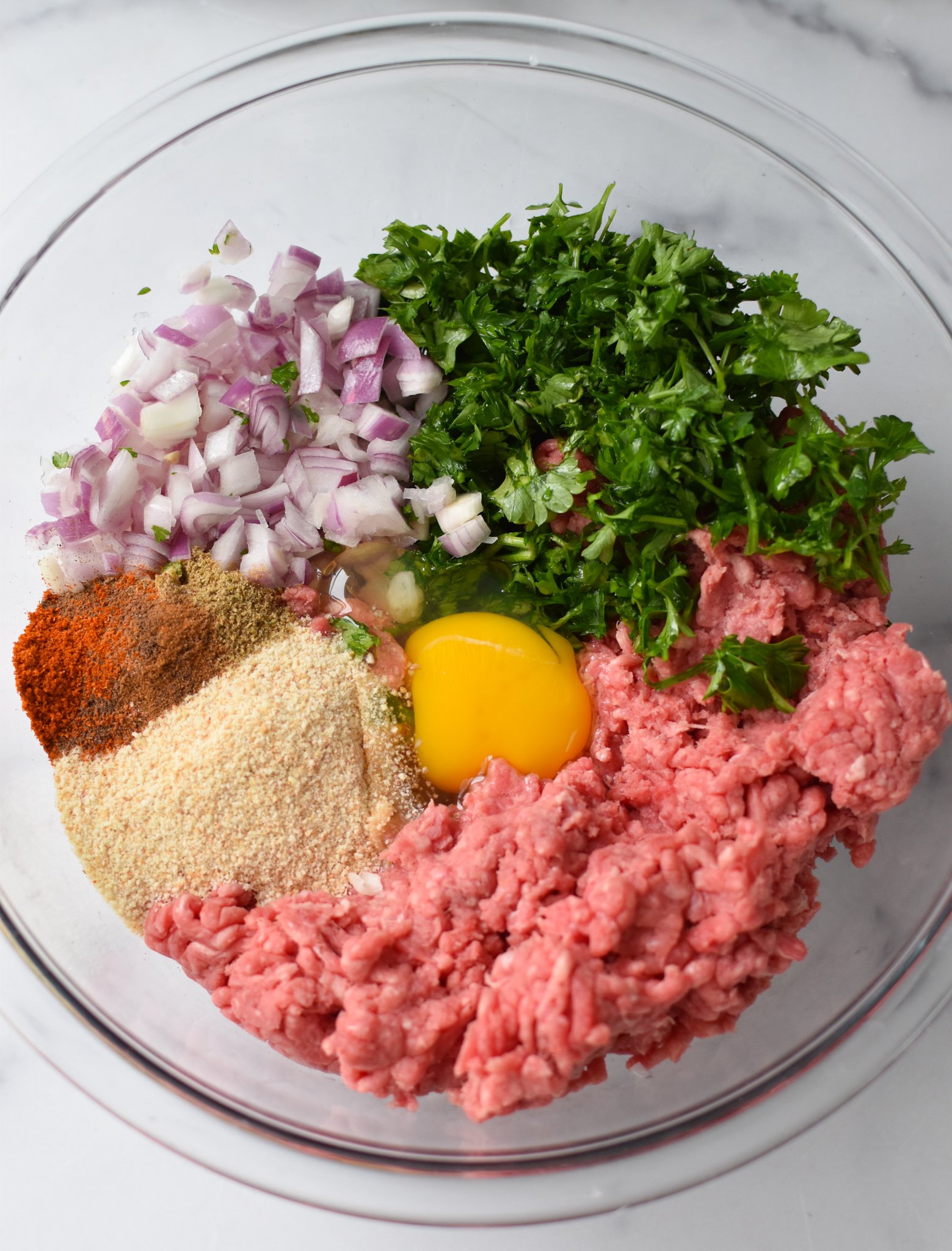 Mediterranean Baked Beef Meatballs ingredients in a bowl. 