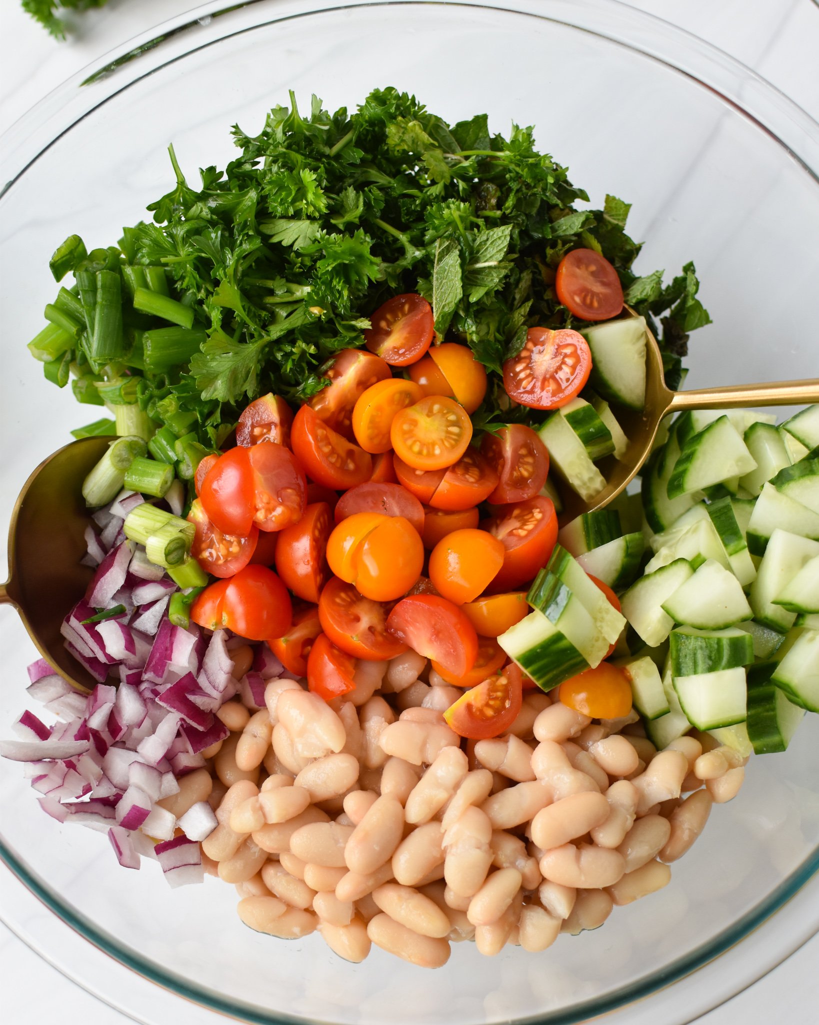 Mediterranean White Bean Salad in a clear bowl. 