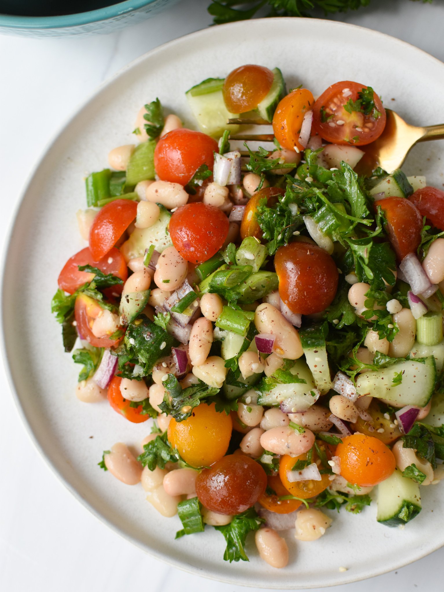 Mediterranean White Bean Salad on a white plate.