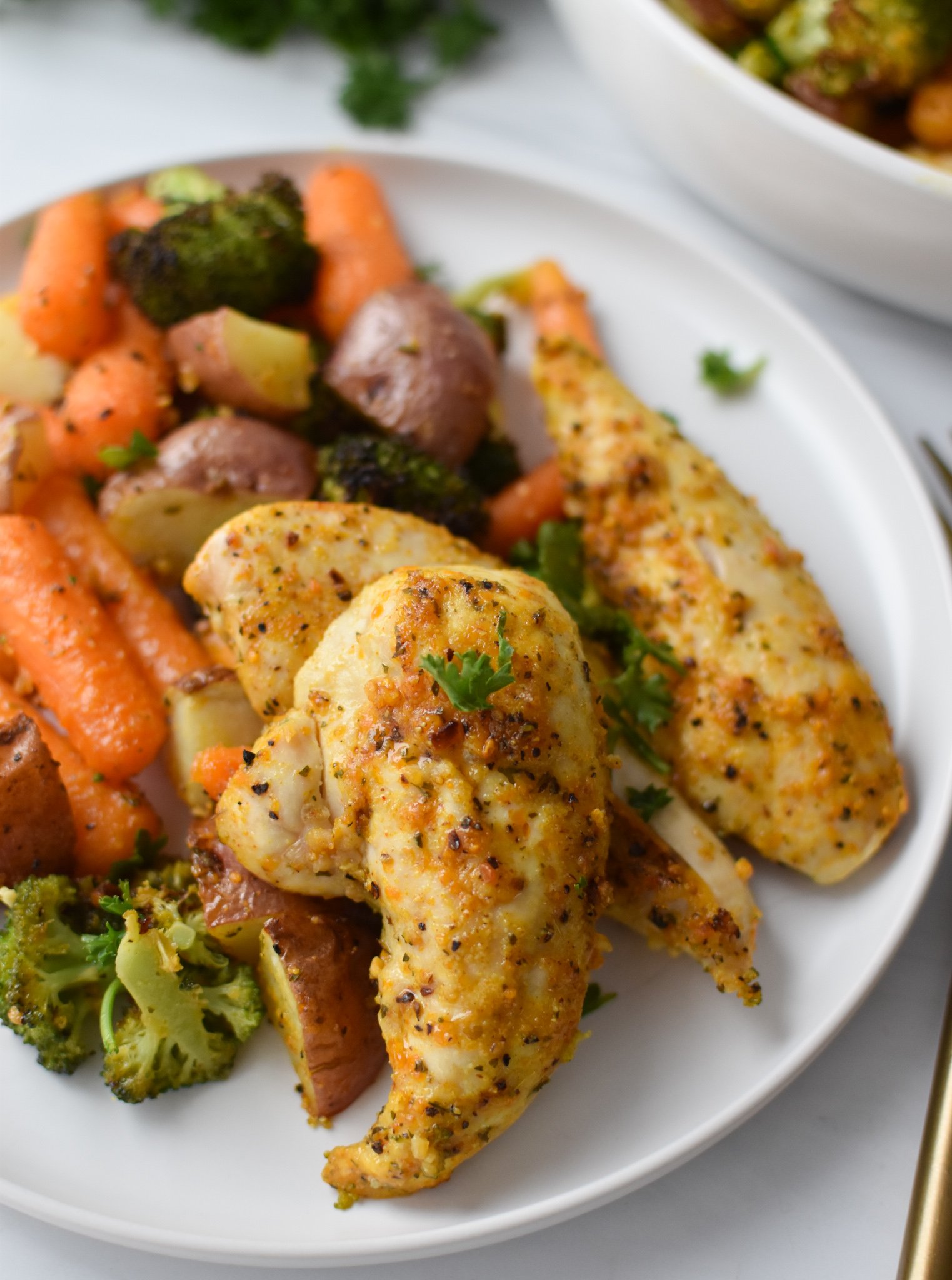 Sheet Pan Lemon Parmesan Chicken Tenders on a white plate. 