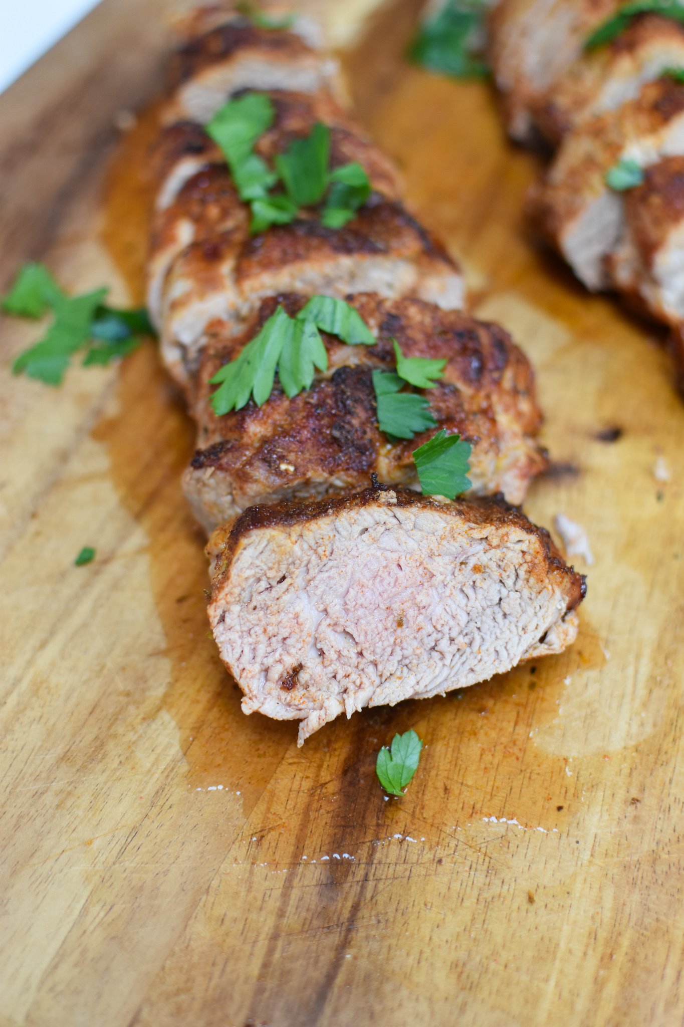 Air Fryer Pork Tenderloin on a cutting board. 