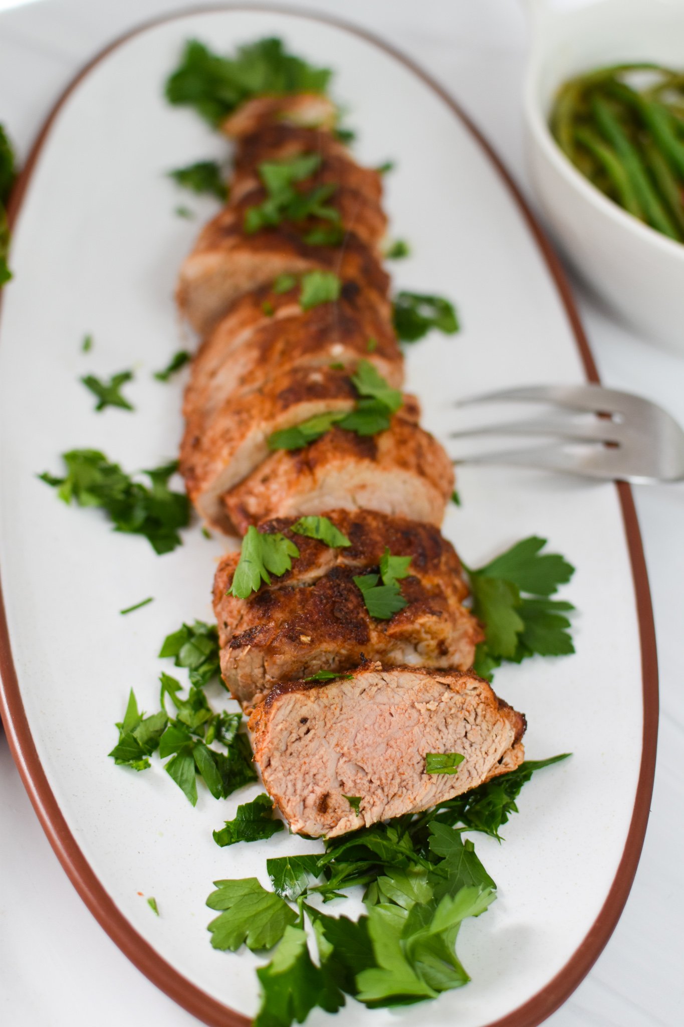 Air Fryer Pork Tenderloin on a white platter.