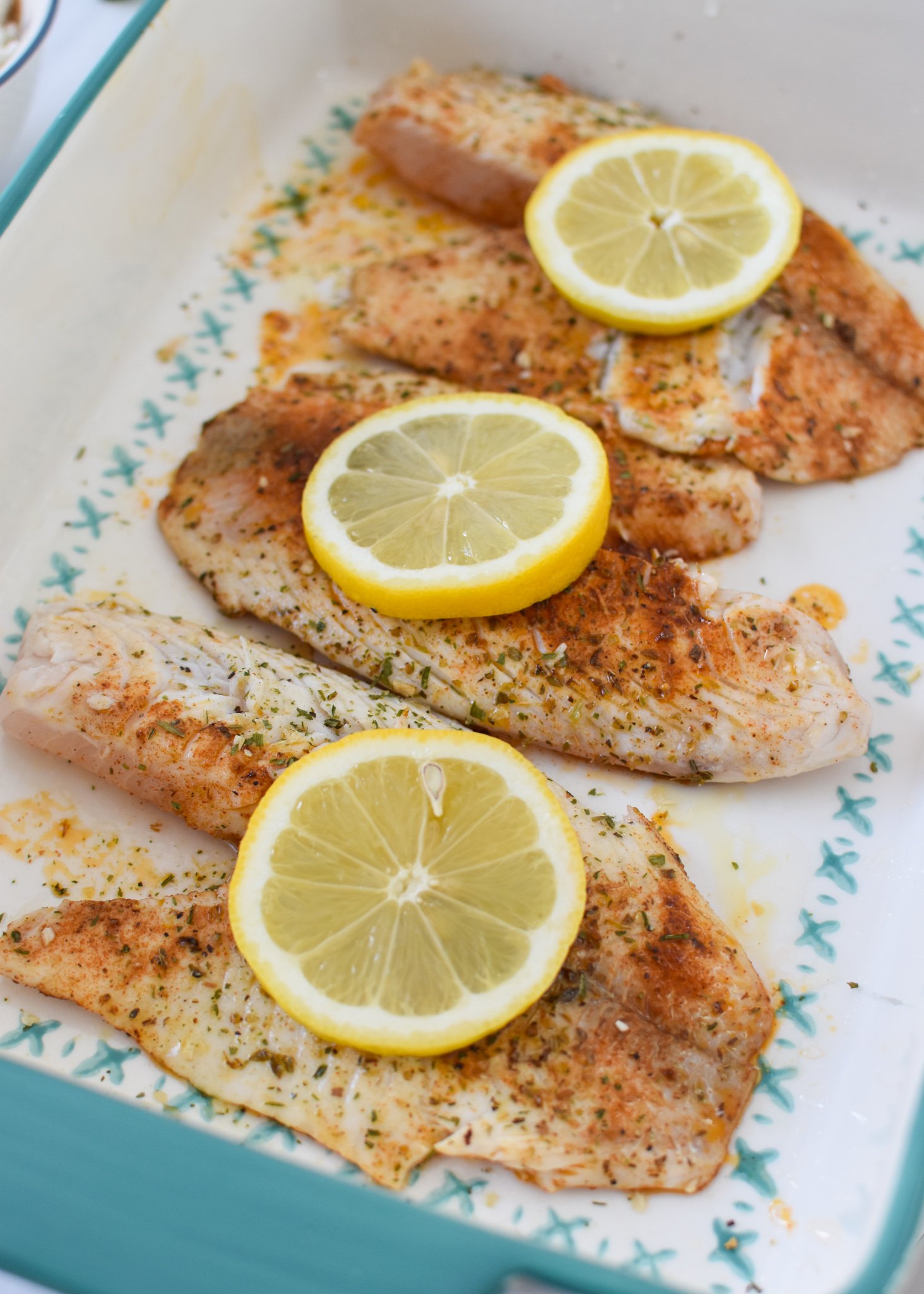 Greek Baked Tilapia in a pan ready to be baked.