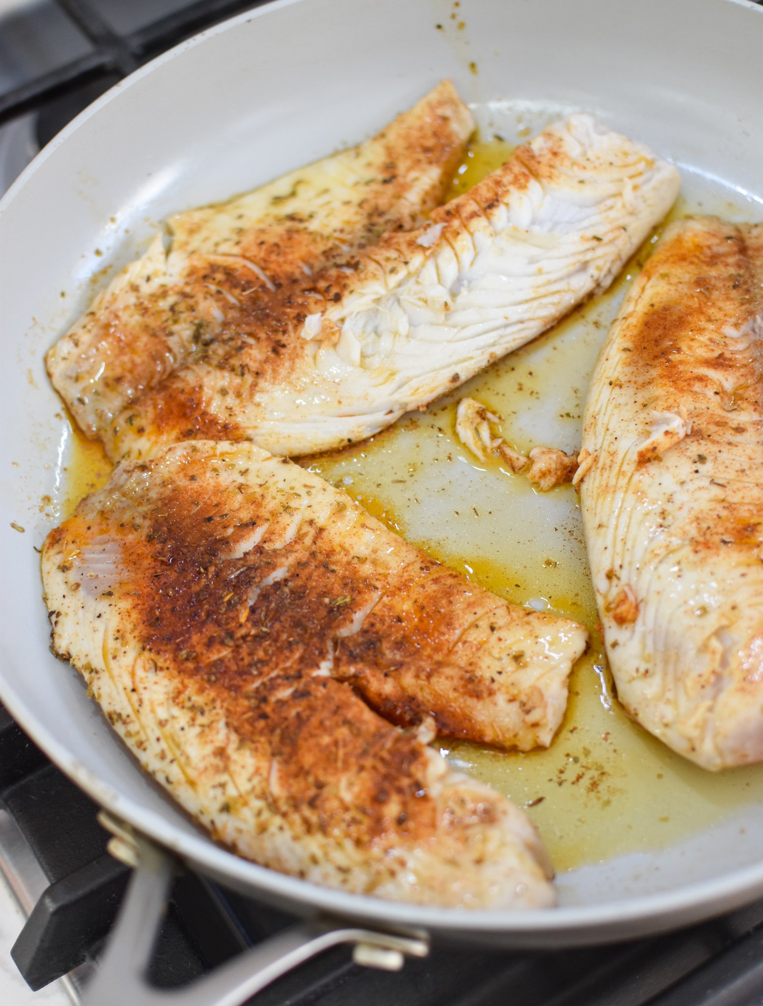 Greek Baked Tilapia in a skillet. 