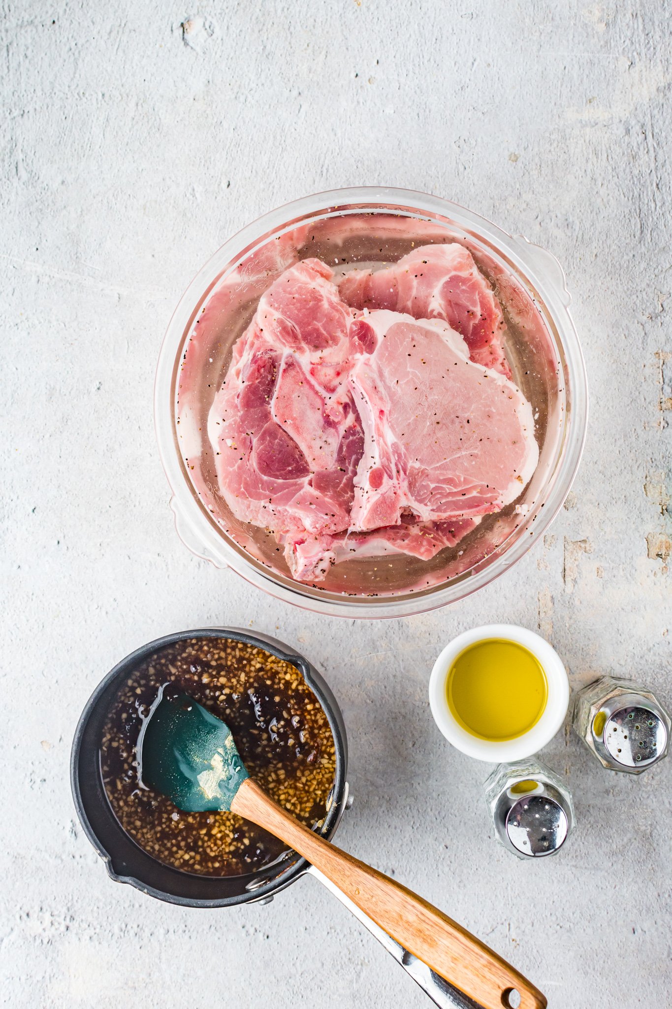 Maple Bourbon Pork Chops Recipe pork chops in a bowl.