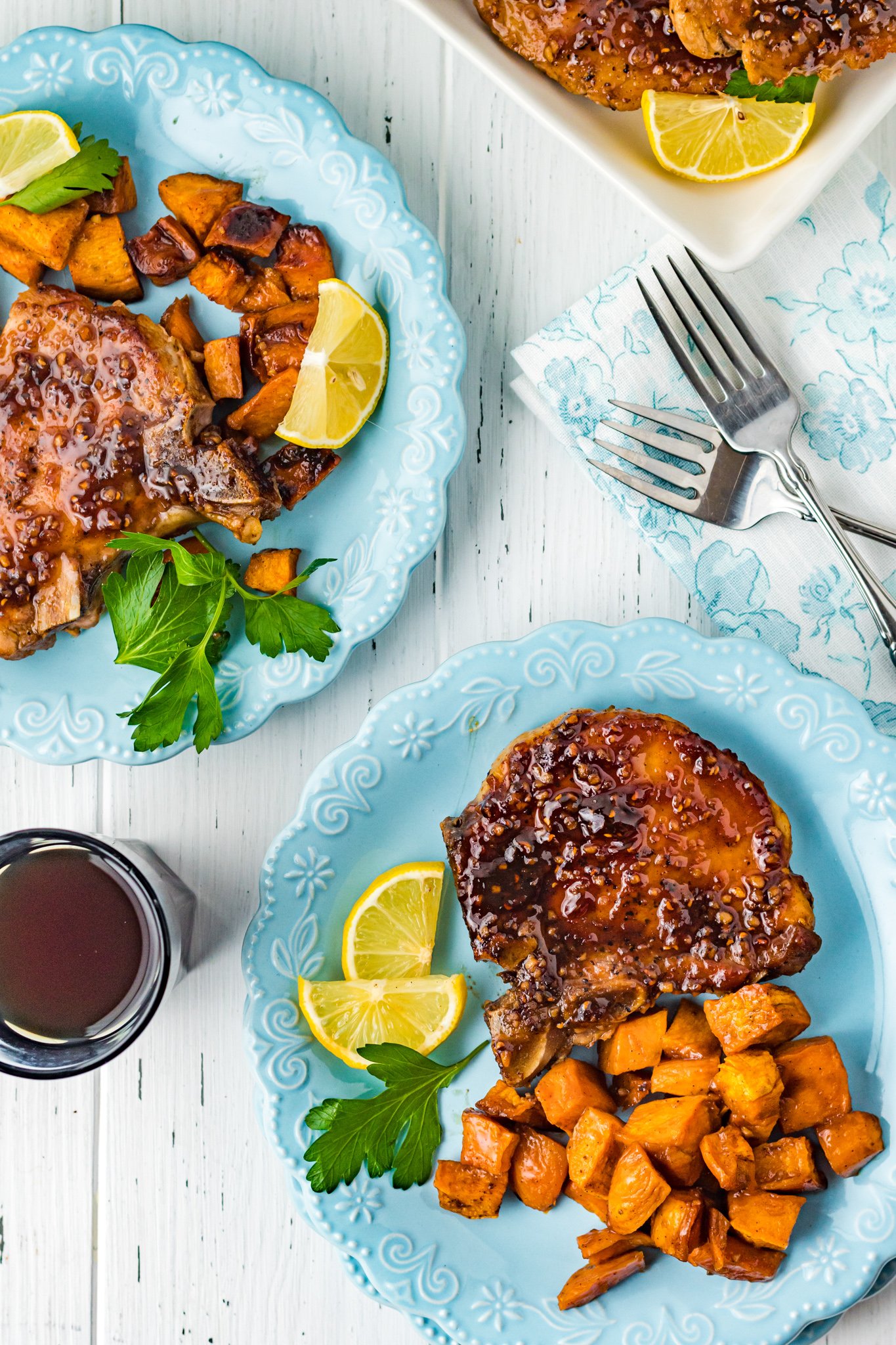 Maple Bourbon Pork Chops Recipe on blue plates.