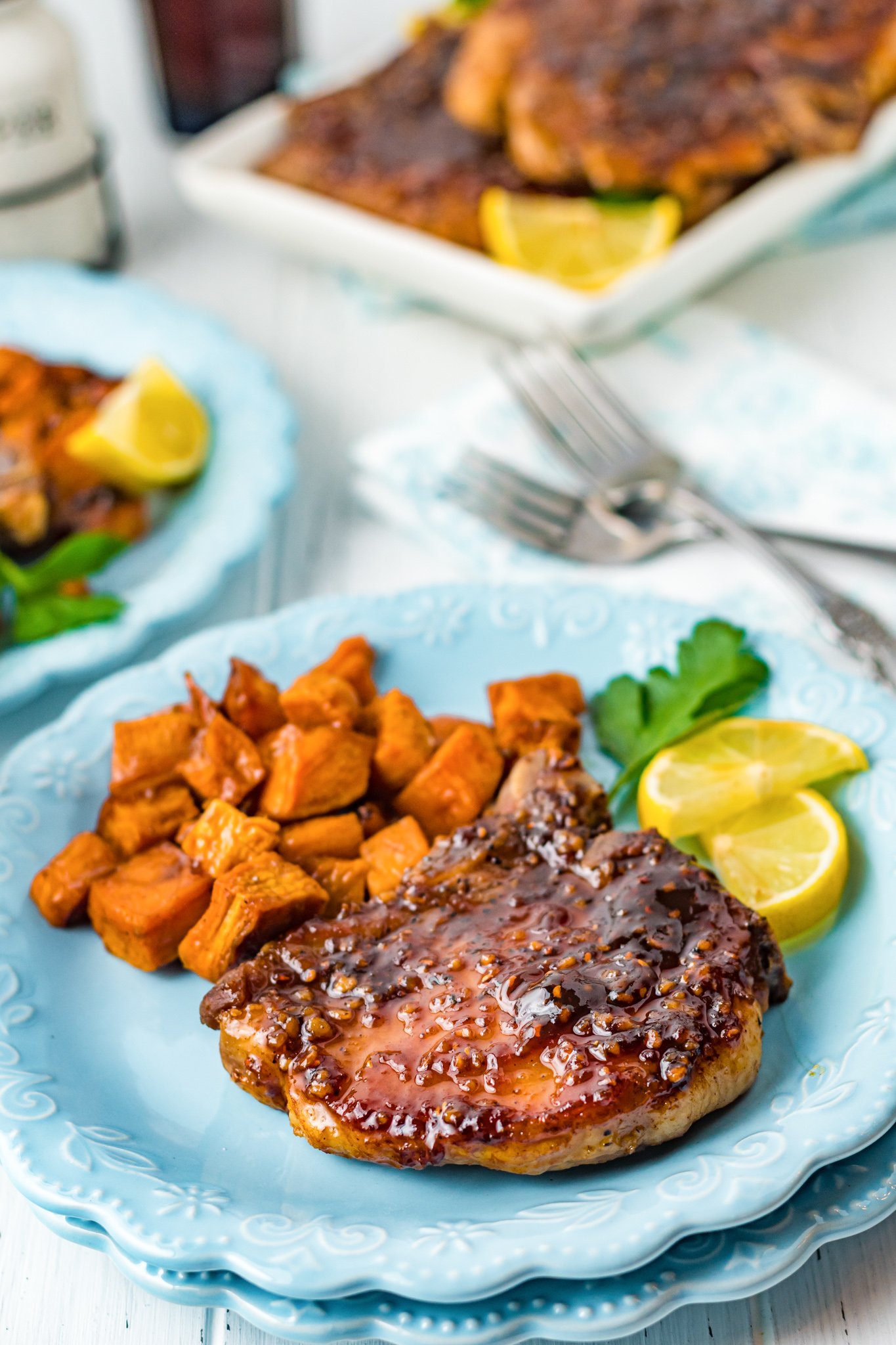 Maple Bourbon Pork Chops Recipe on a blue plate.