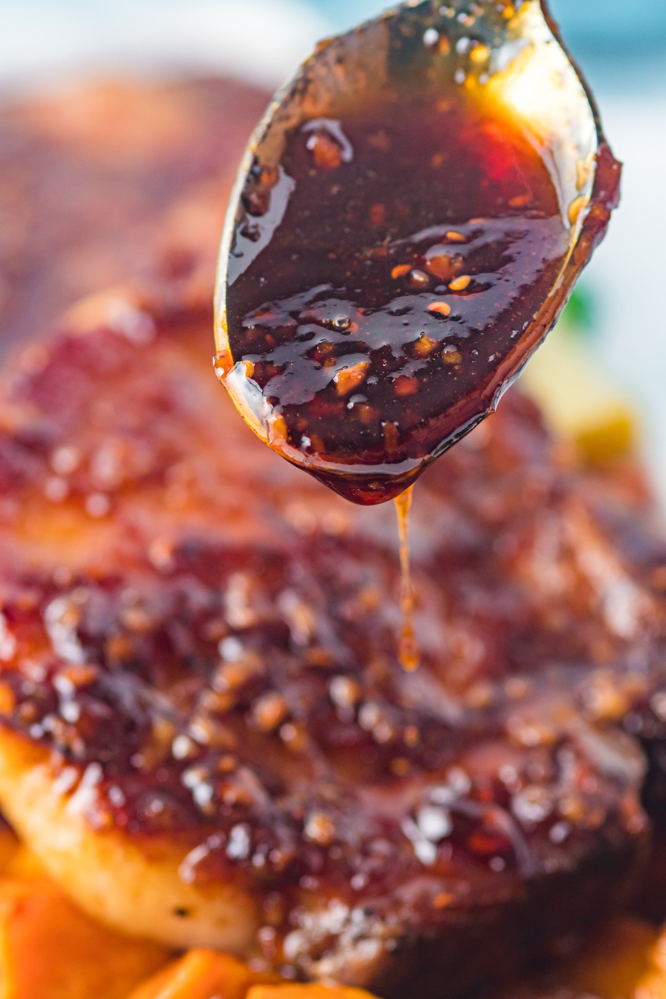  Maple Bourbon Pork Chops Recipe glaze on a spoon. 