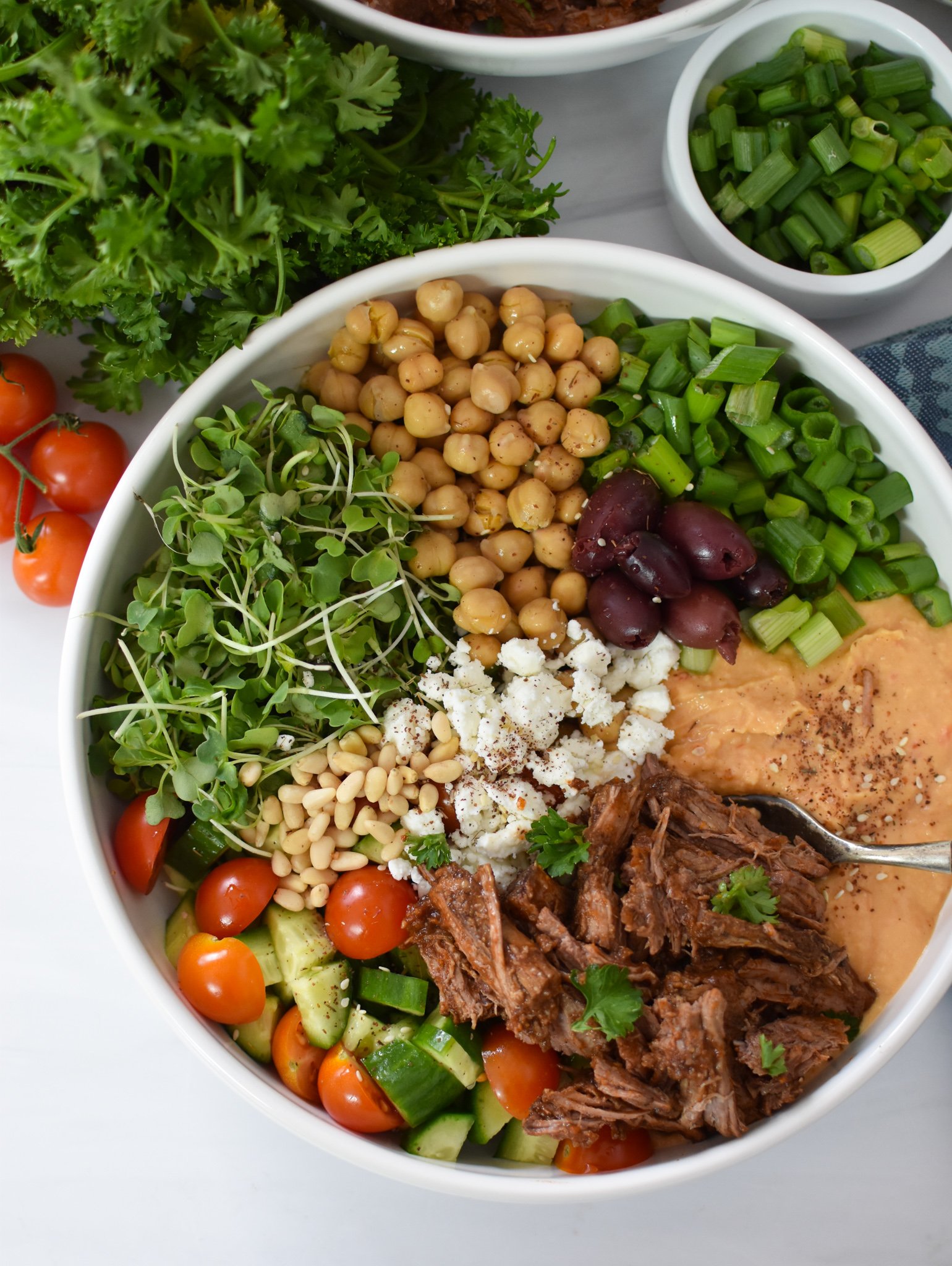 Slow Cooker Shredded Beef Hummus Bowls with olives and hummus. 