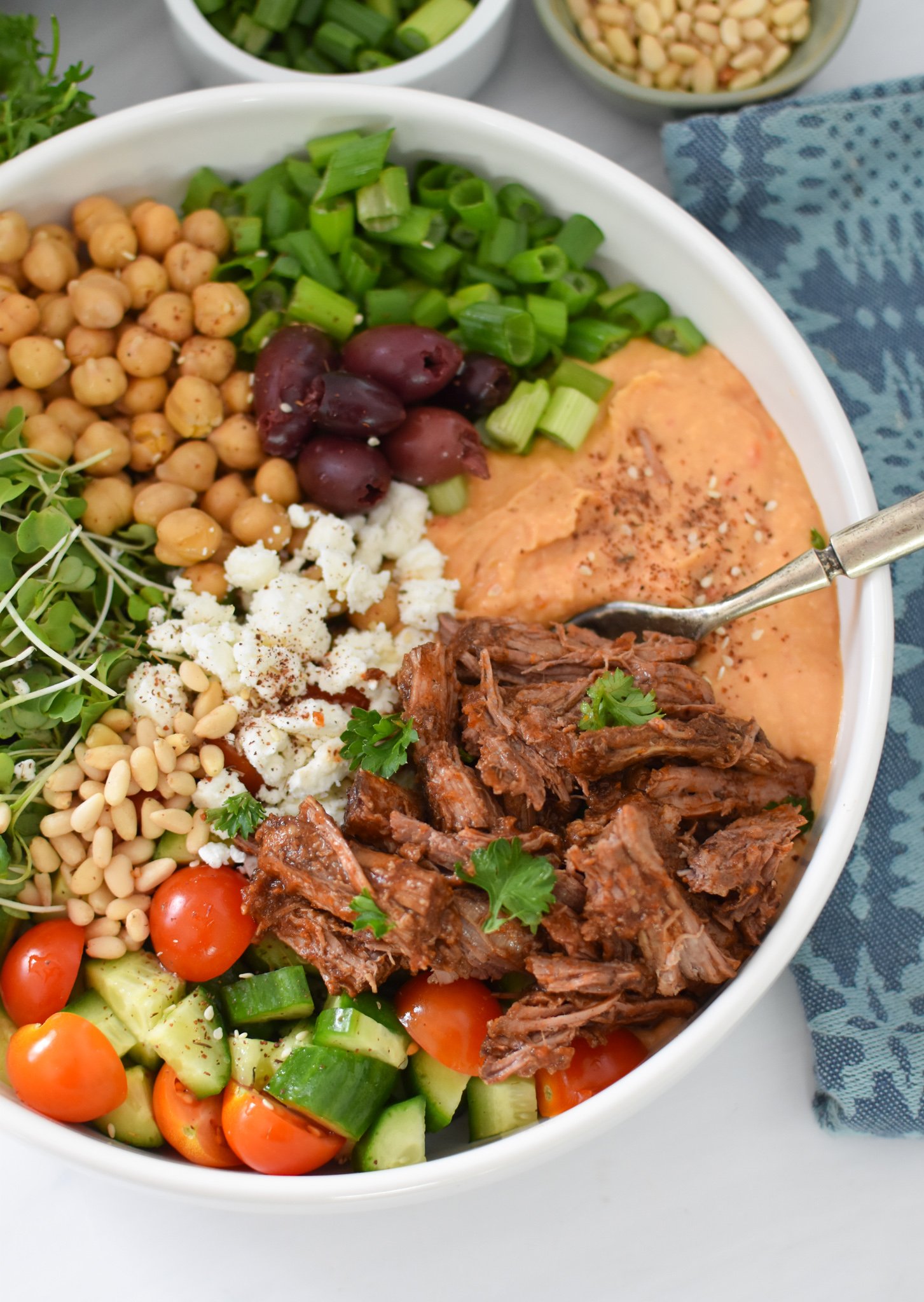 Slow Cooker Shredded Beef Hummus Bowls with a fork in a bowl. 