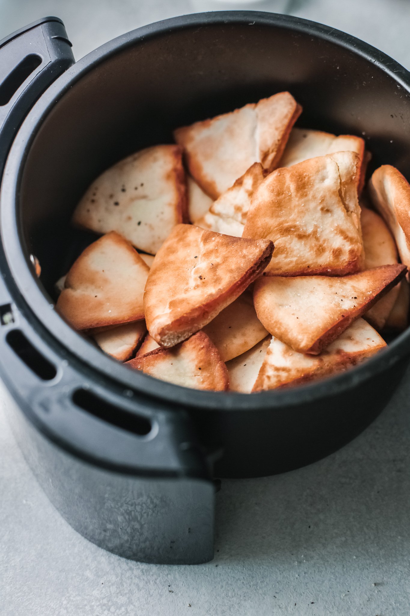 Air Fryer Pita Chips in an air fryer.