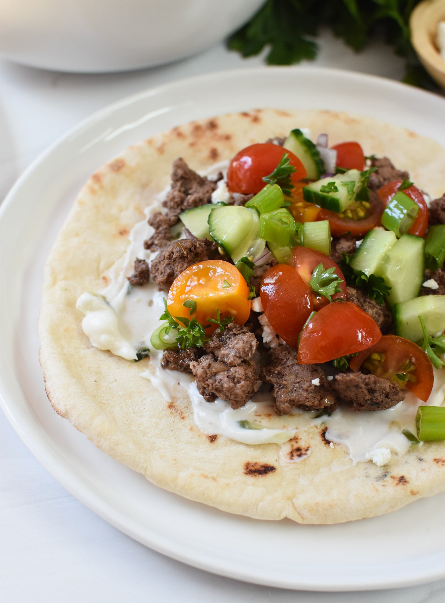 Spiced Ground Lamb Pita Recipe on a pita with tzatziki.