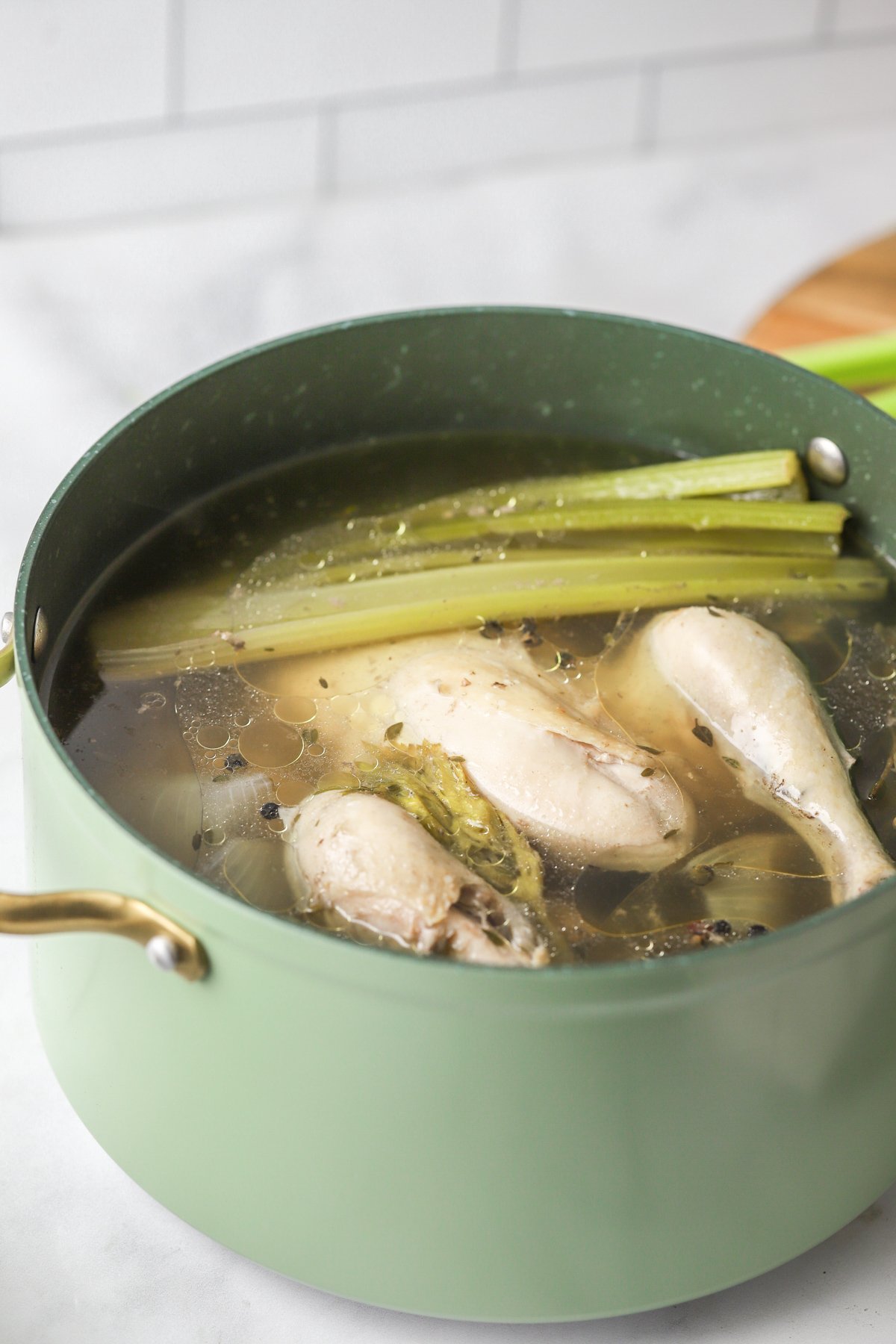 Homemade Chicken Broth in a pot with water.
