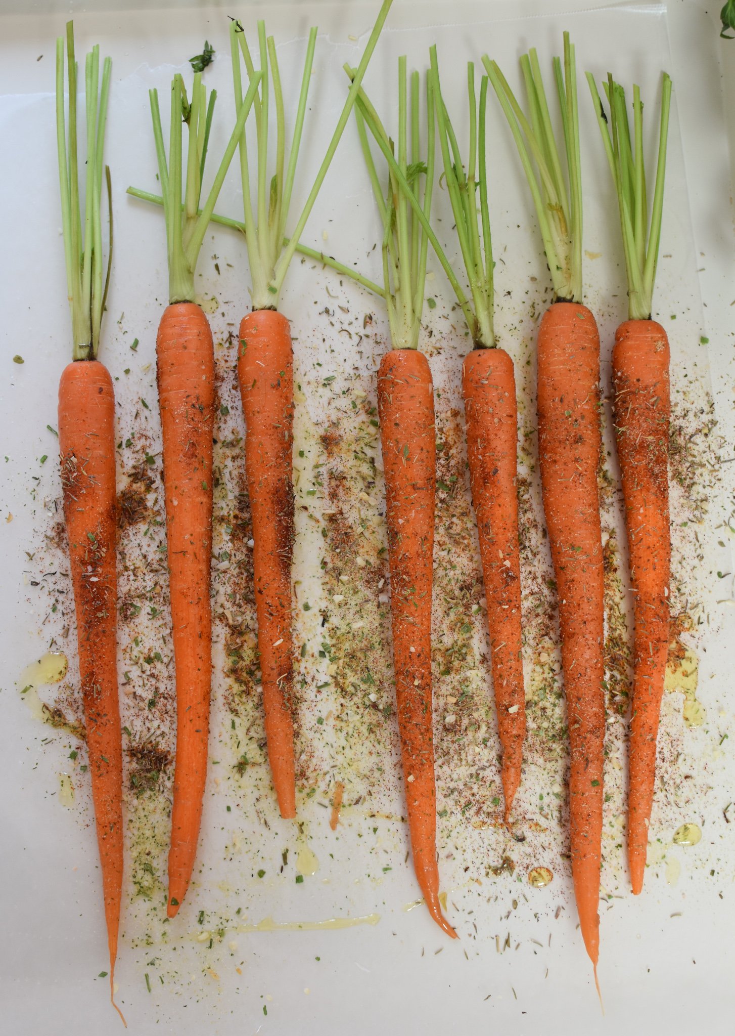 Roasted Carrots with Pistachios carrots on a baking sheet. 