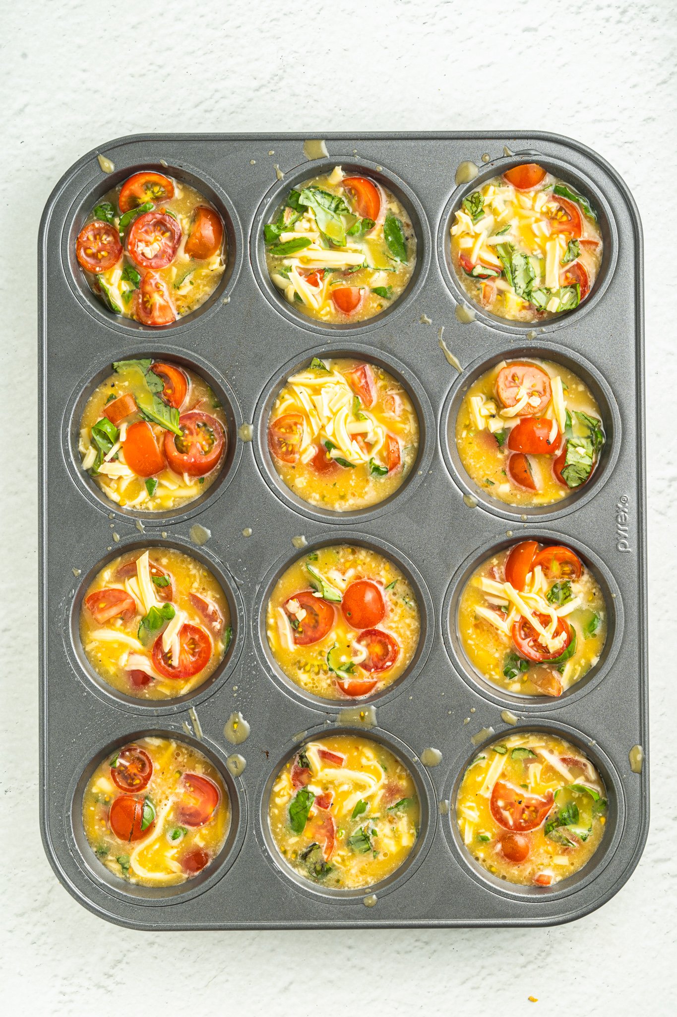 Caprese Egg Muffins eggs in a muffin tin. 