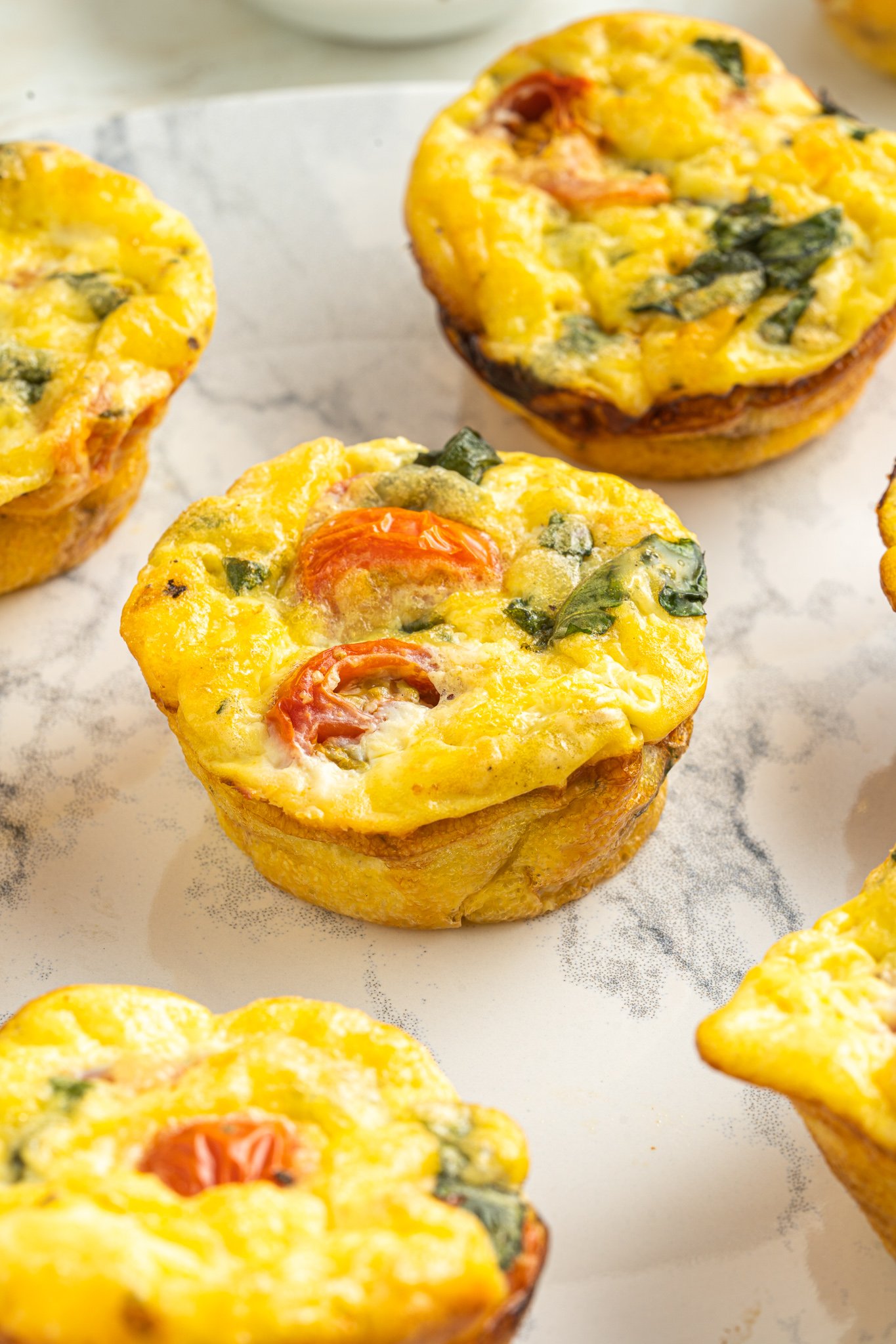Caprese Egg Muffins on a marble platter.