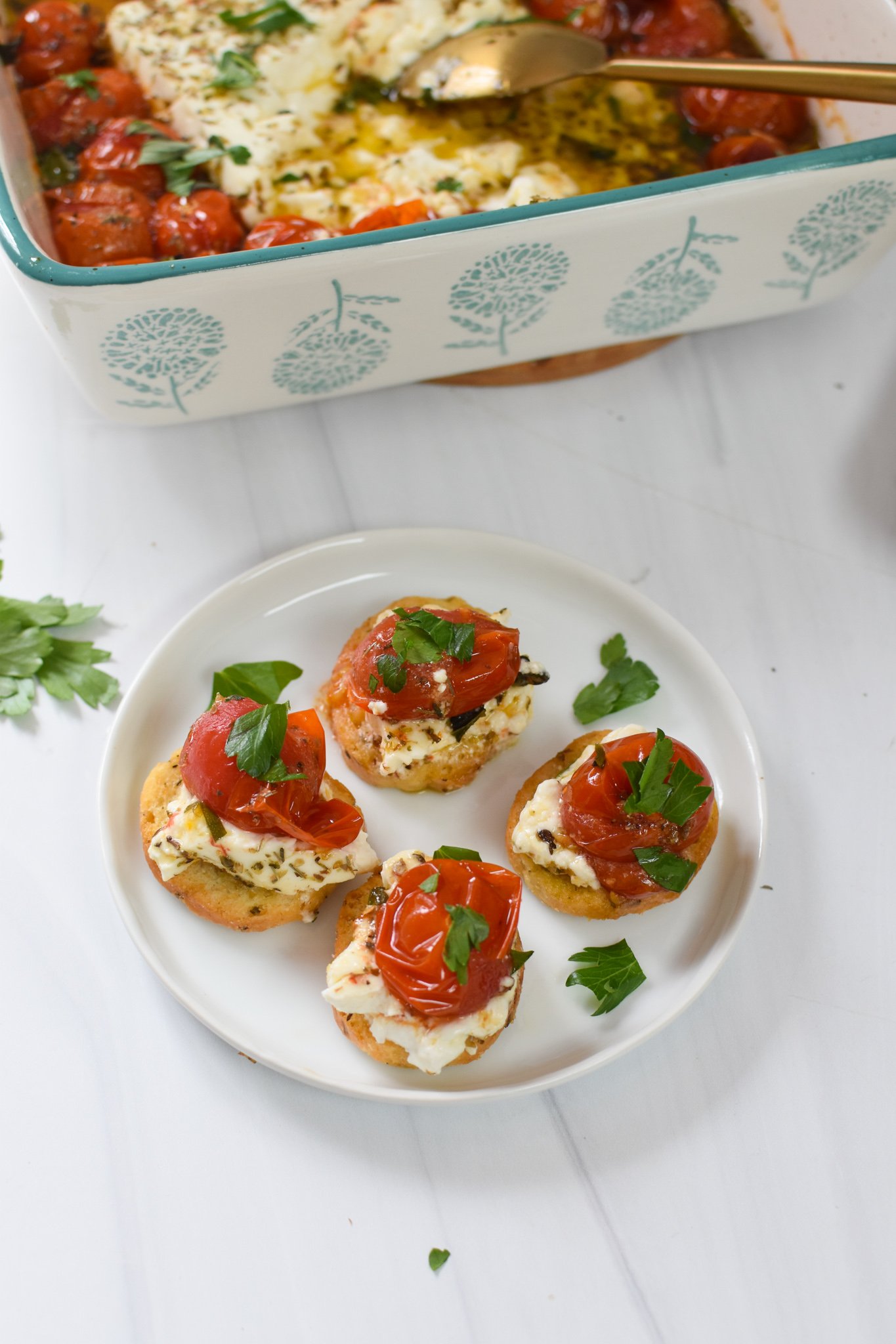  Easy Baked Feta Recipe with crostini on a plate.