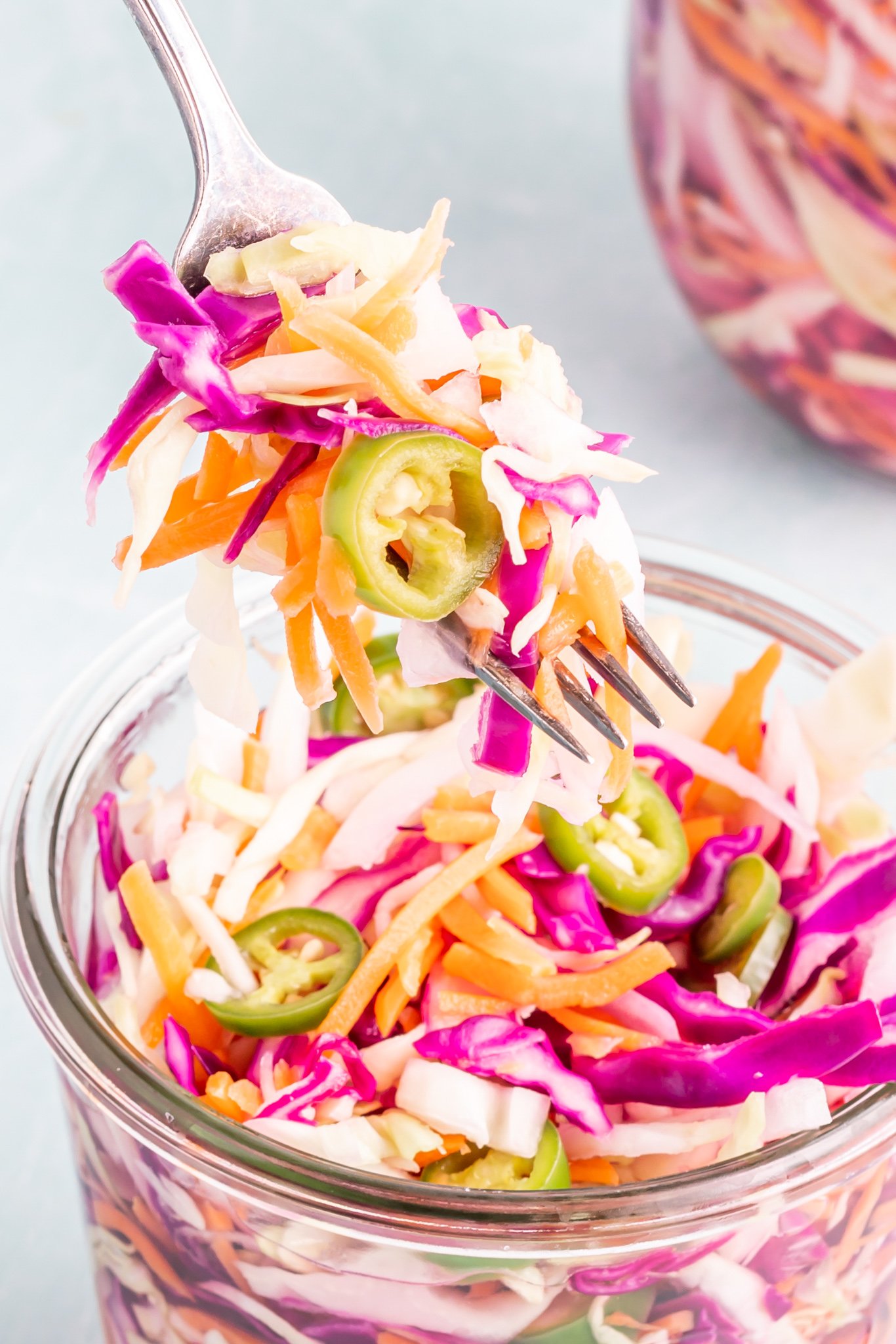 Easy Curtido Recipe in a glass jar with a fork.