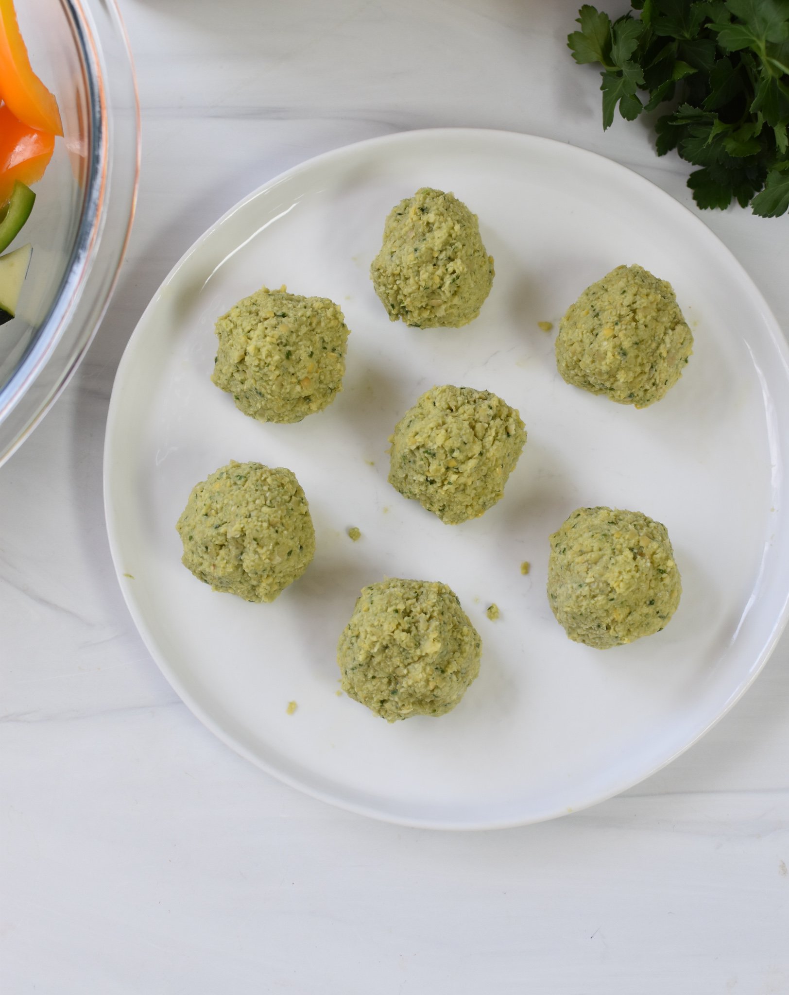 Falafel Vegetable Kabobs falafel formed into balls on a plate. 