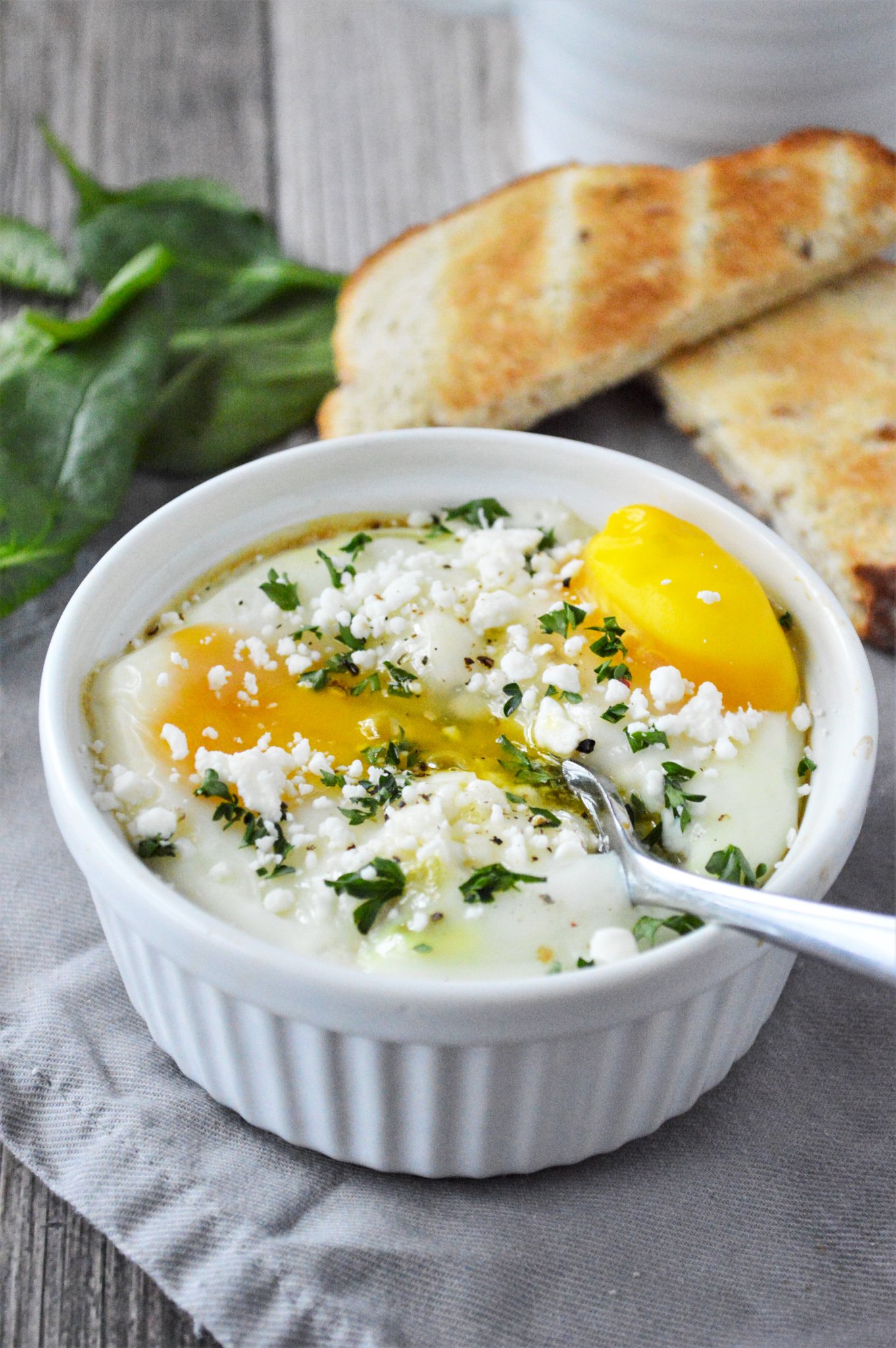 Greek Baked Eggs with spoon.