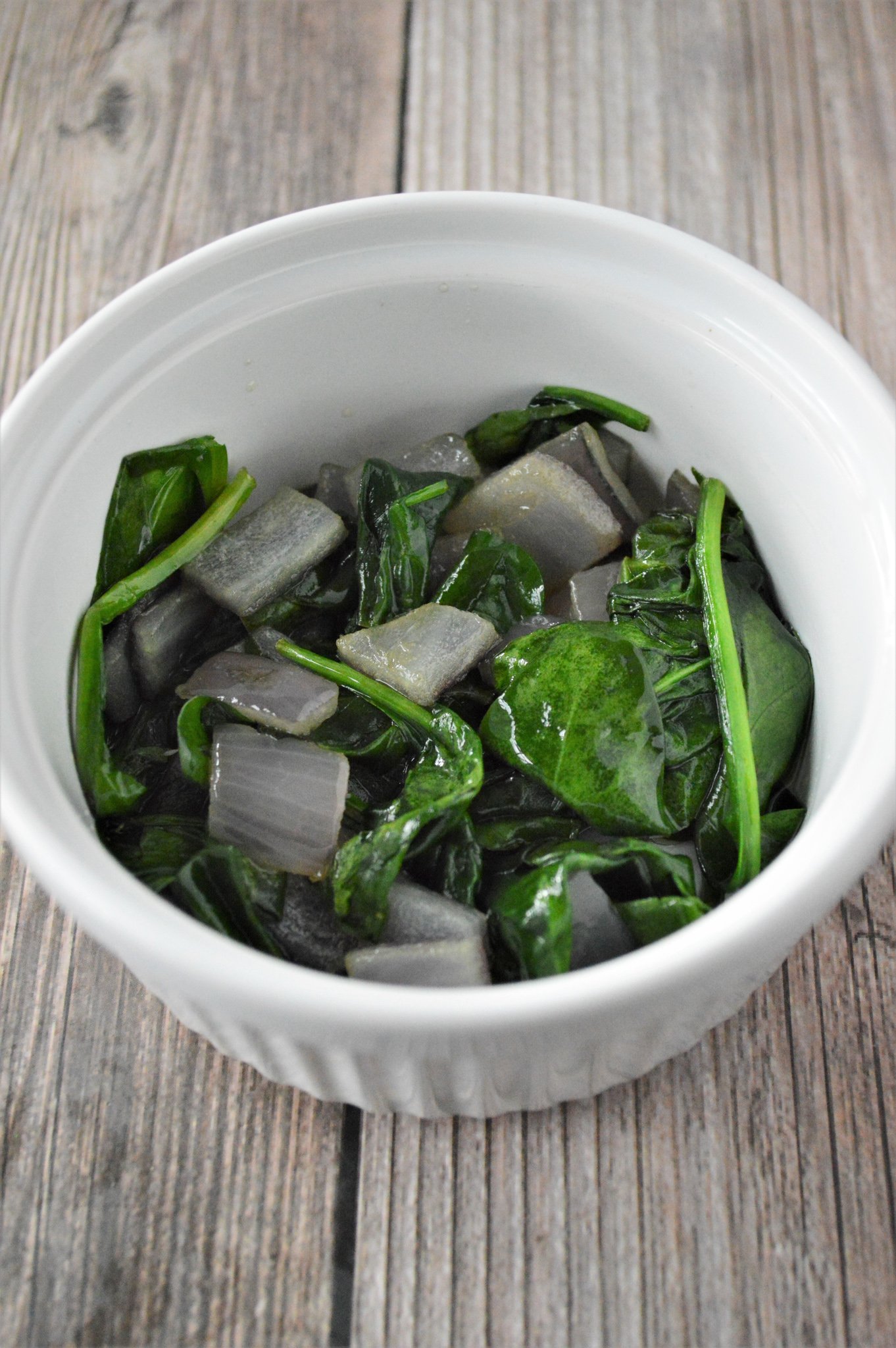 Greek Baked Eggs spinach in a dish.