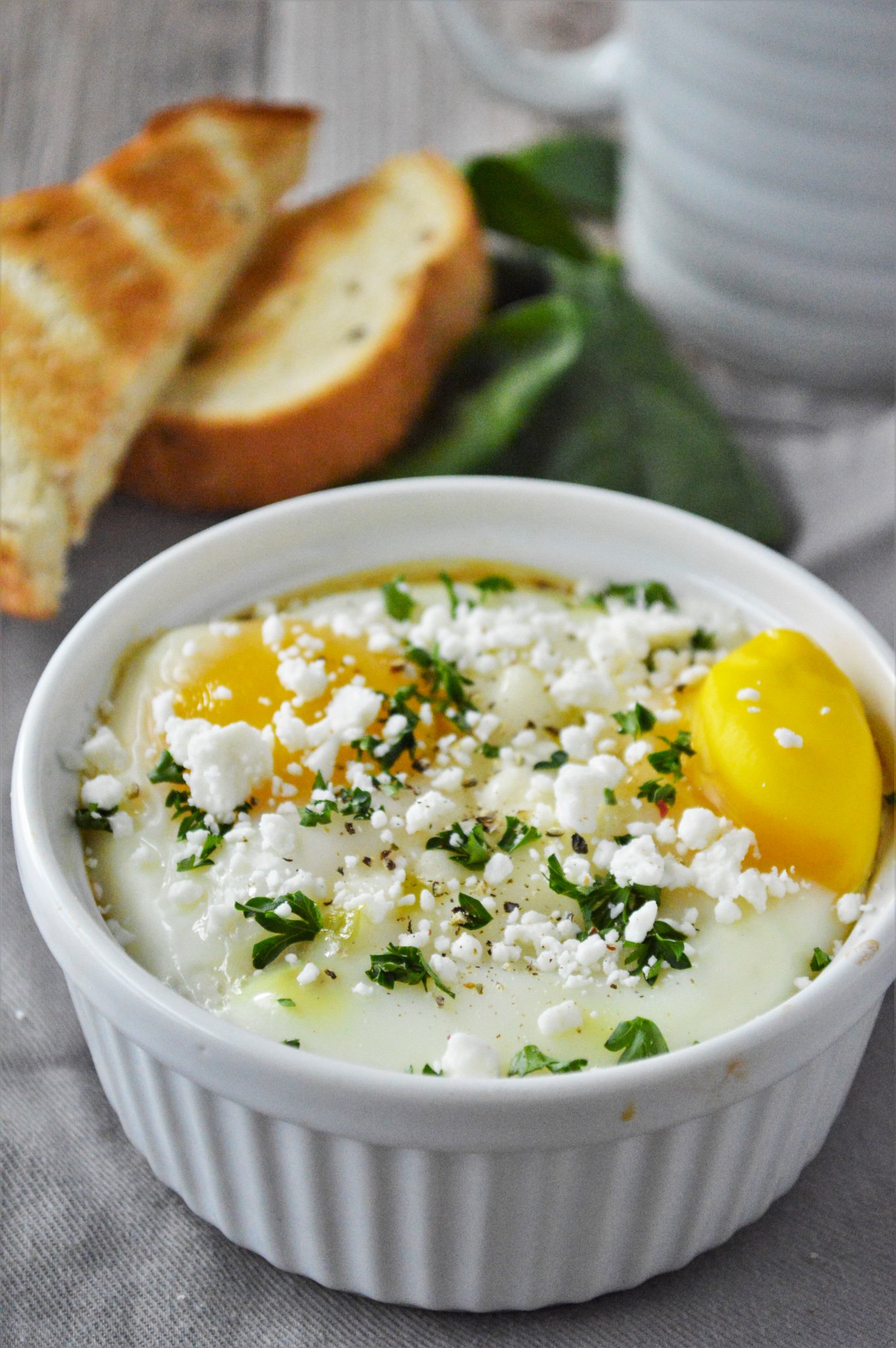 Greek Baked Eggs in a white dish.