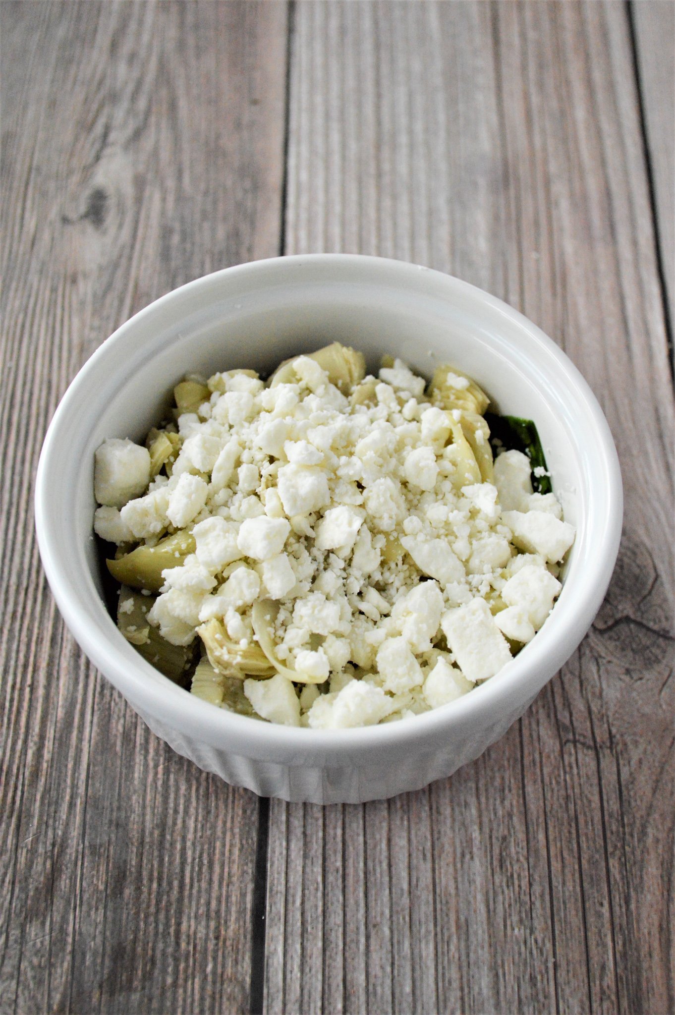 Greek Baked Eggs feta on top of the spinach.