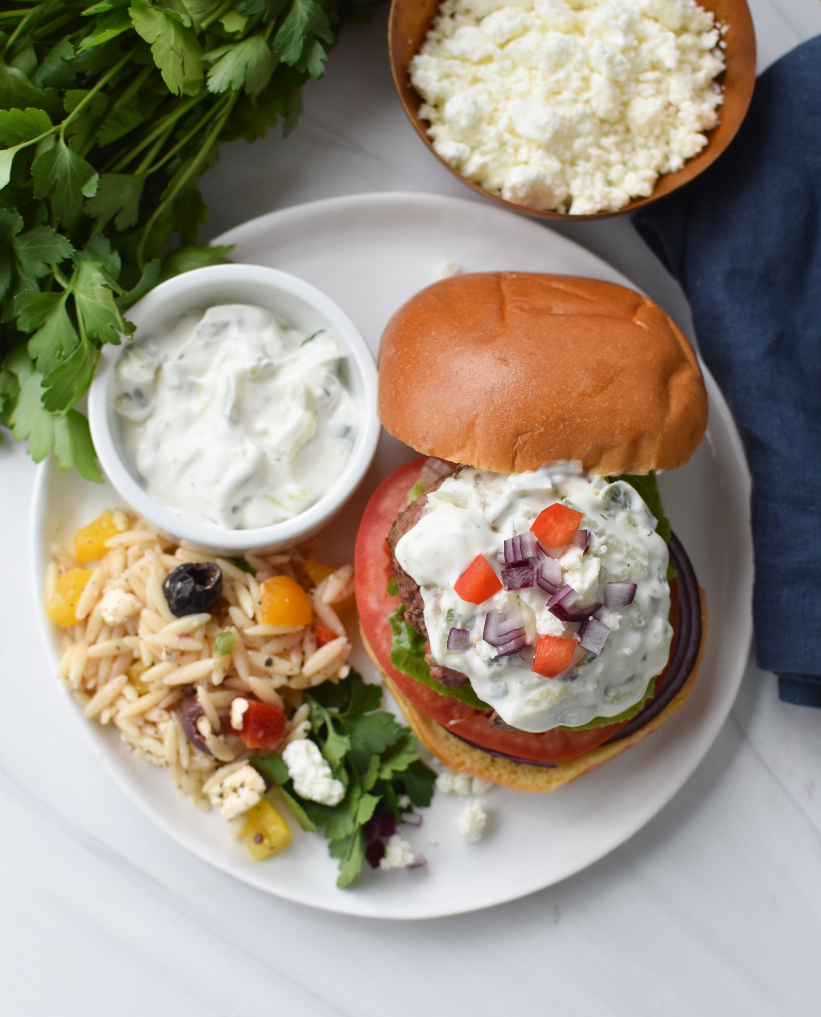 Feta Burger with Tzatziki burger on a plate. 