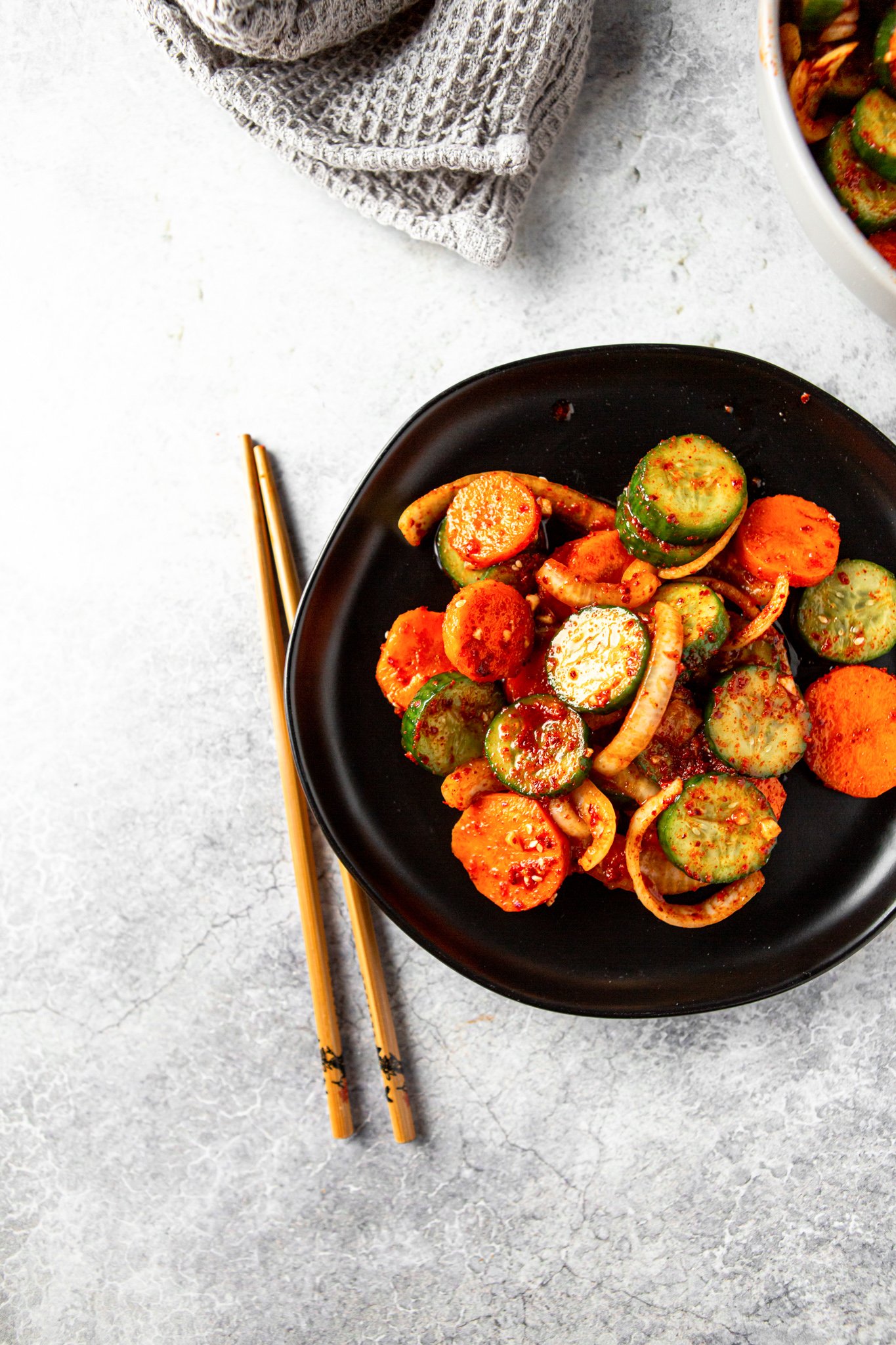 Quick Korean Cucumber Kimchi with chopsticks.
