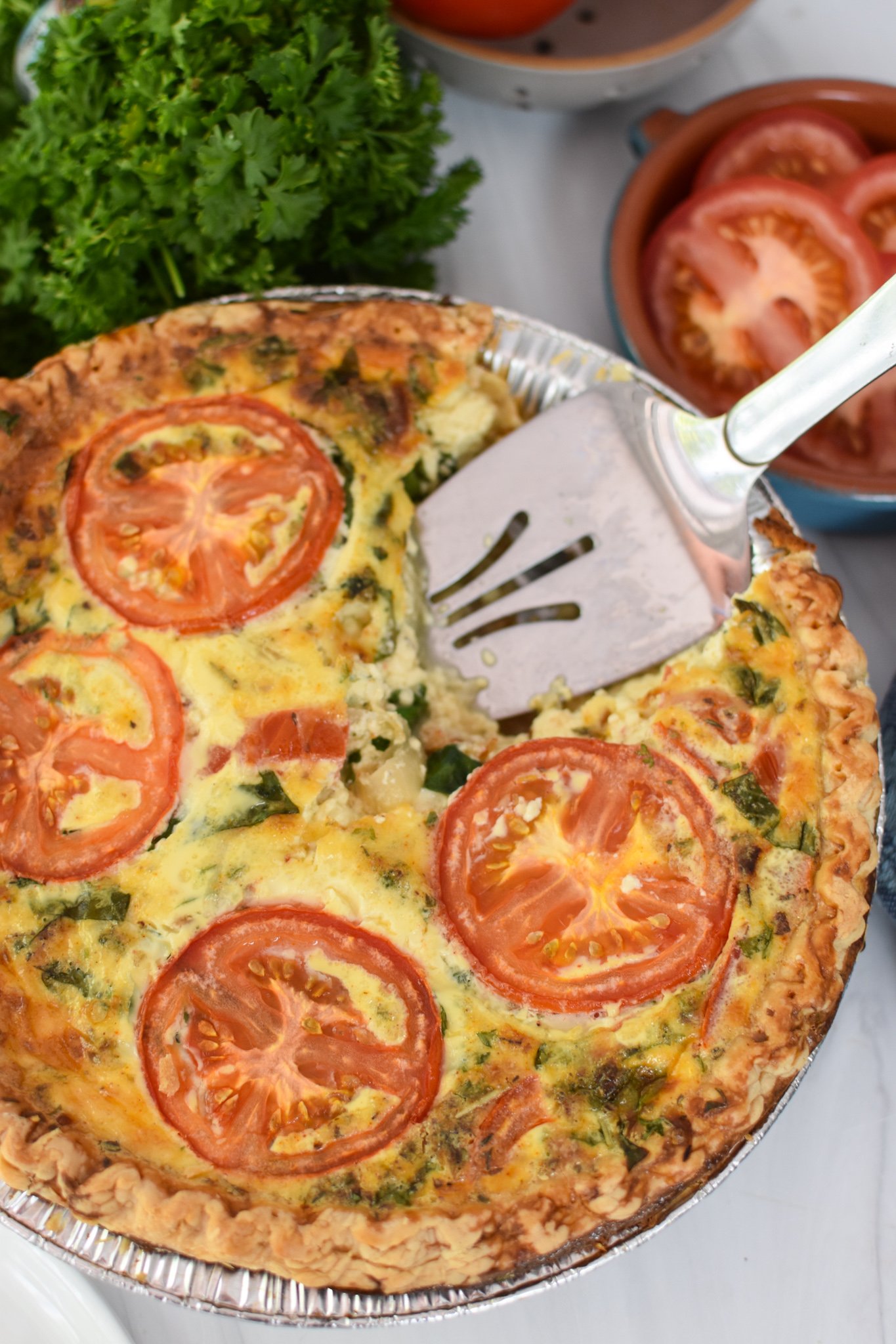 Caprese Quiche Lorraine Recipe with pie server. 
