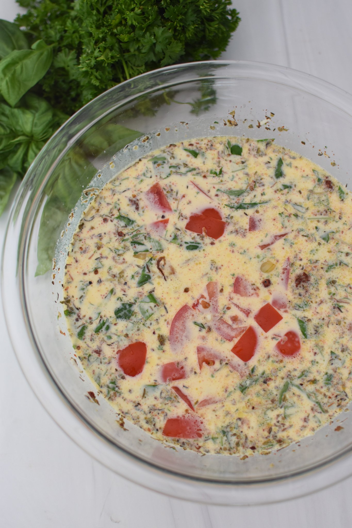 Caprese Quiche Lorraine Recipe egg mixture in a bowl. 